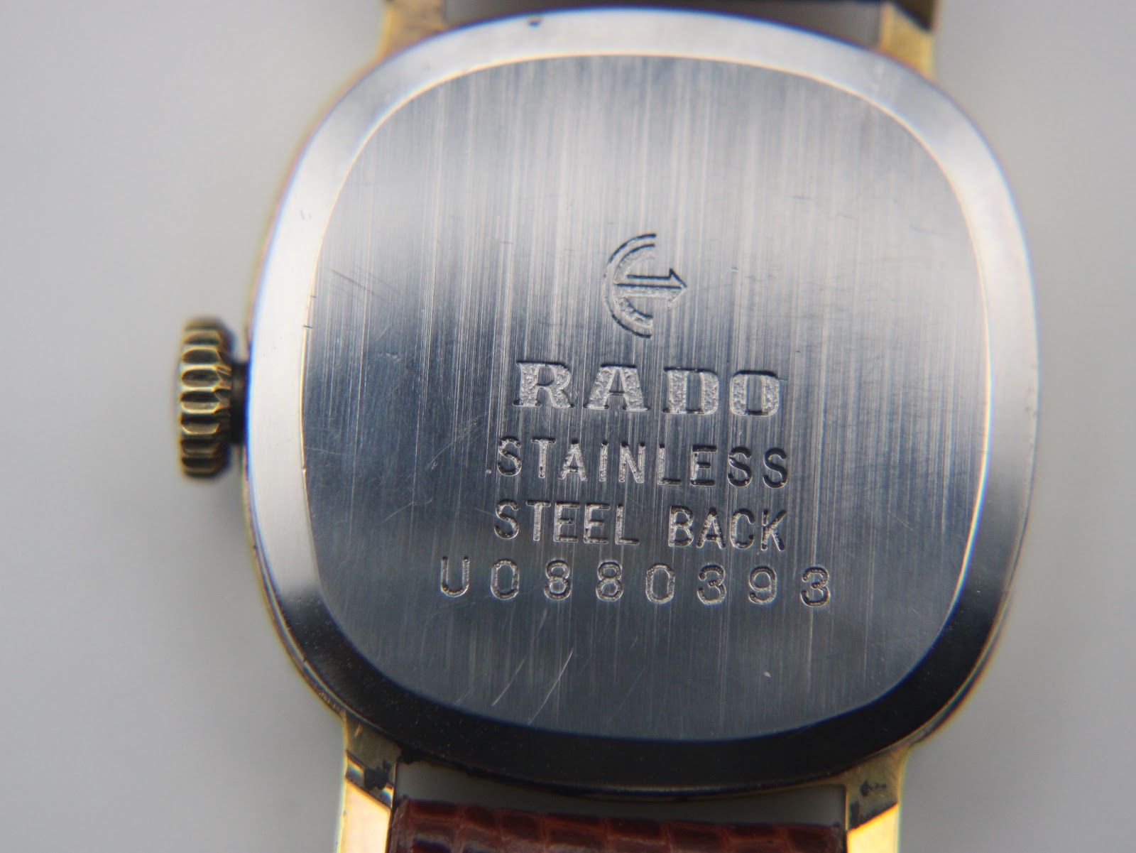Close-up of the watch's brushed stainless steel case back, engraved with 'RADO', 'STAINLESS STEEL BACK', and serial number U0880393.