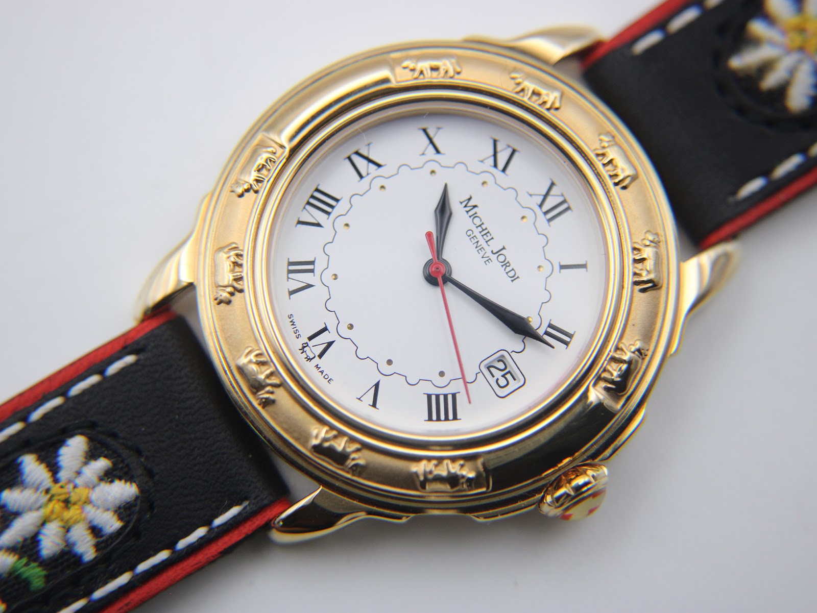 Detailed close-up of the watch dial, showing the black Roman numerals, outer minute track, date window at 3 o'clock, and signature.