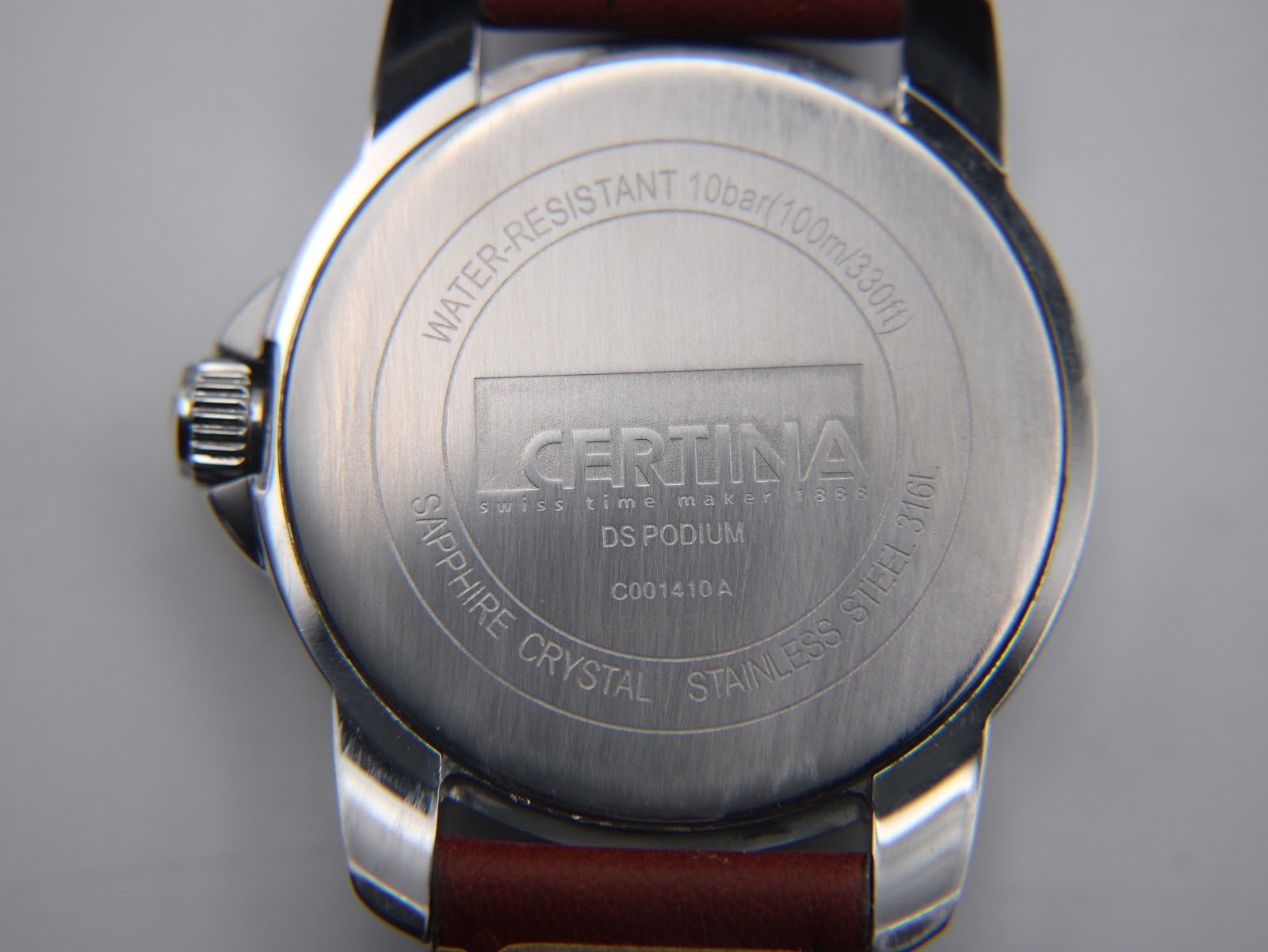Close-up of the stainless steel case back with Certina DS Podium engraving, water resistance, and sapphire crystal details.
