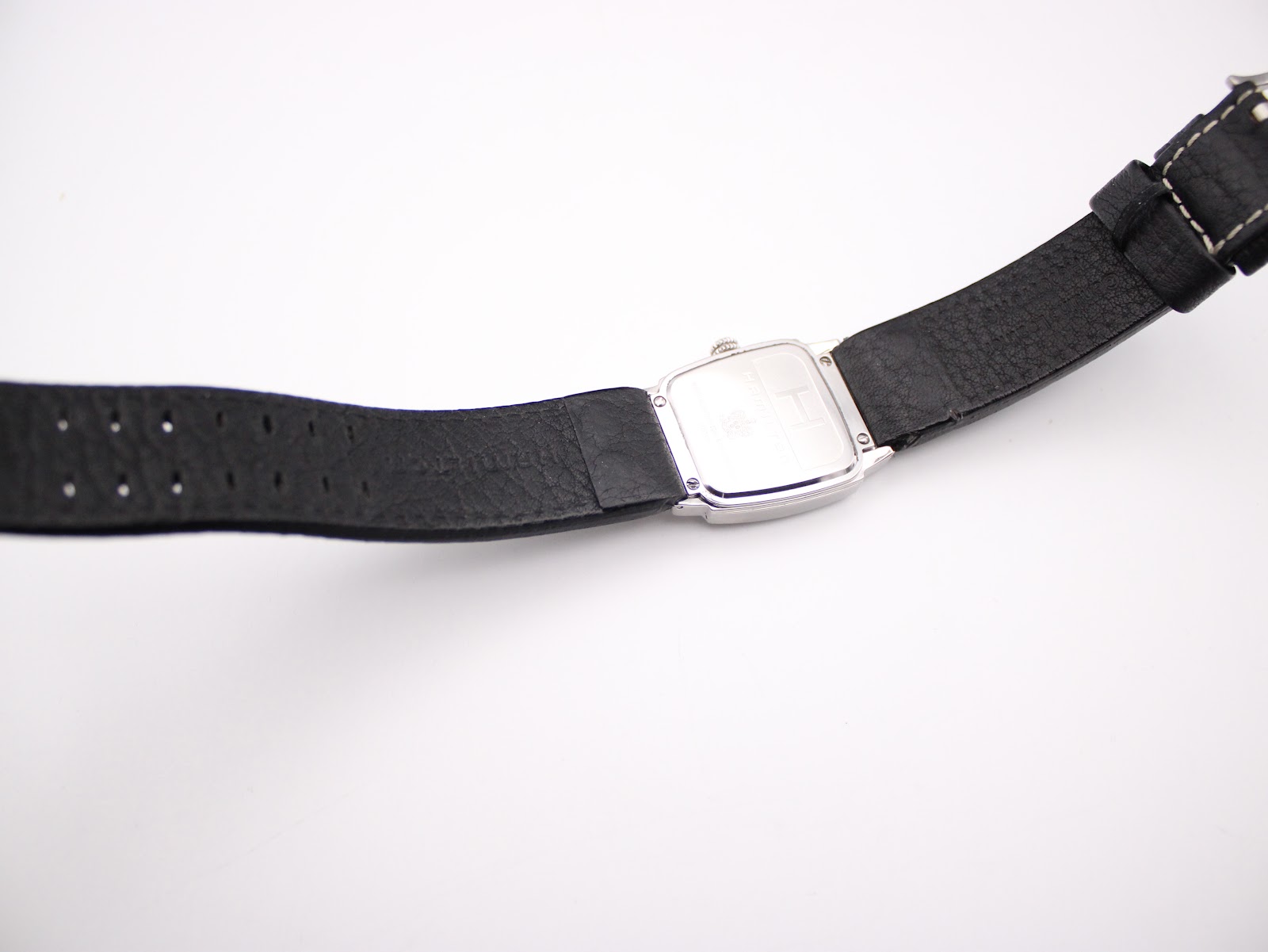 Full length view of the Hamilton H163110 watch from the back, showing the case back and strap.