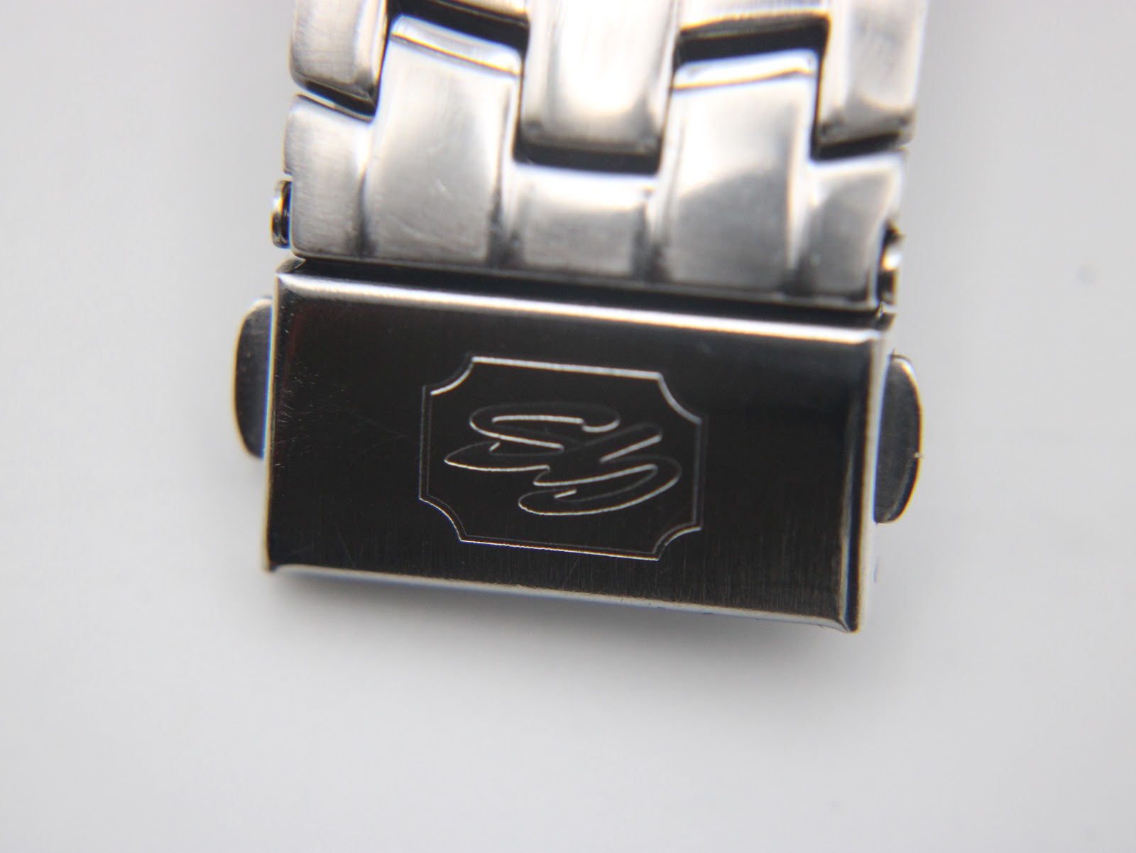 Close-up of the stainless steel bracelet clasp, clearly showing the engraved Gianni Sabatini logo.