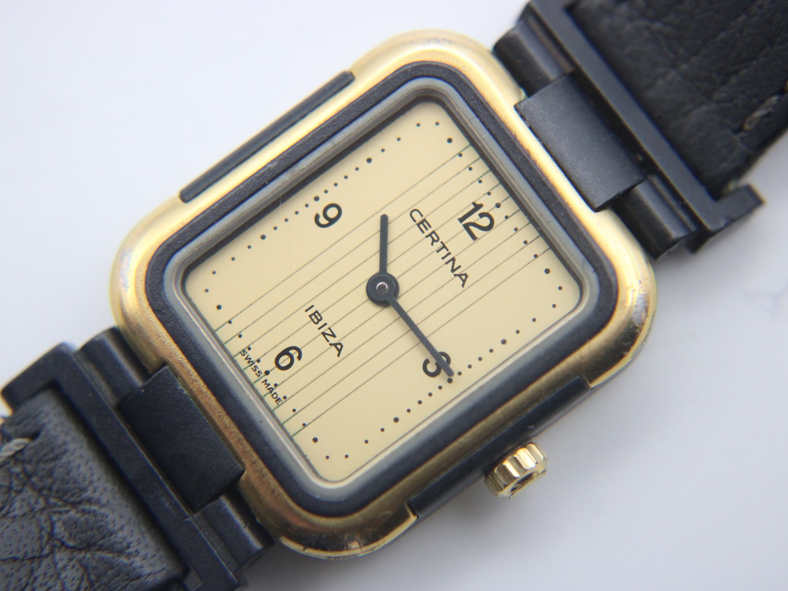 Detailed close-up of the Certina Ibiza watch dial, showing the cream colour, horizontal texture, and "Certina Ibiza" branding
