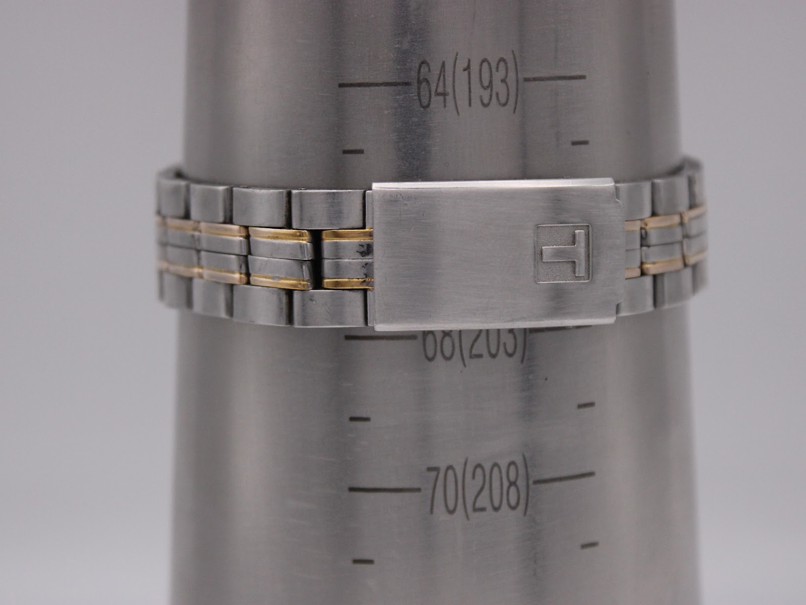 Tissot PR 50 watch bracelet on a wrist sizing gauge, showing a circumference measurement of 203mm.