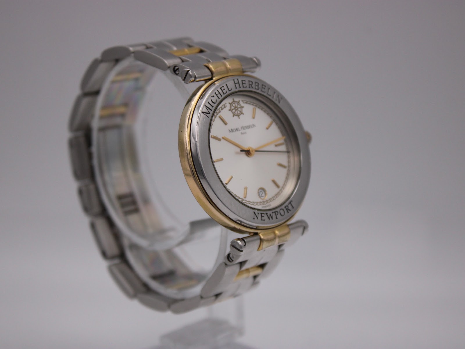 Another angled view of the Michel Herbelin Newport watch, highlighting the case profile and integrated two-tone bracelet.