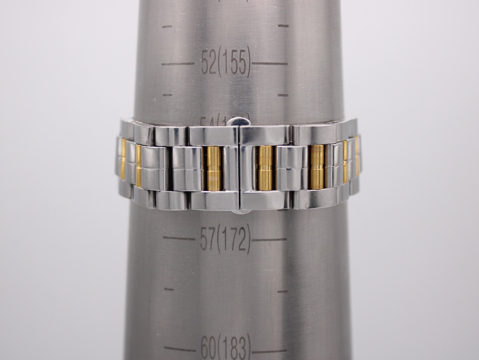 The watch's two-tone stainless steel bracelet wrapped around a wrist sizing cone, indicating a circumference of approximately 172mm.