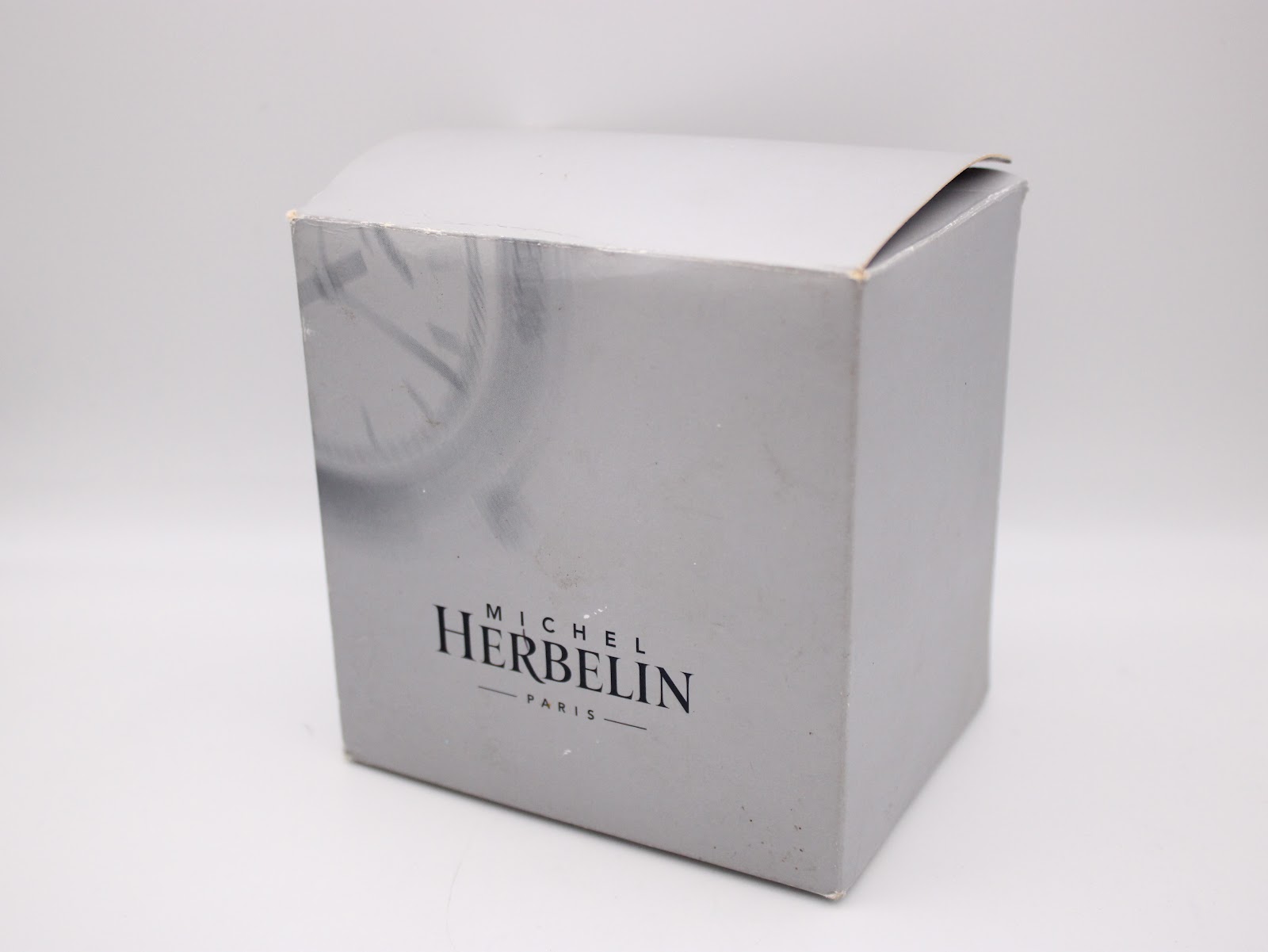 Original Michel Herbelin grey cardboard outer box with the brand logo printed on the front.