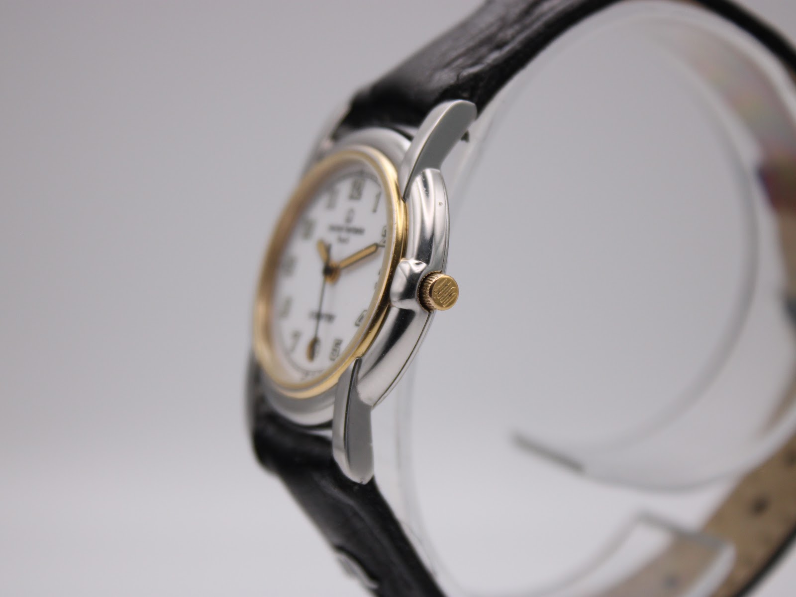 Right side profile of the Michel Herbelin watch, showing the gold-tone crown and two-tone case.