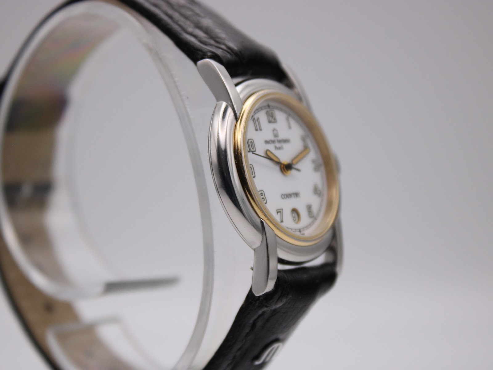 Left side profile of the Michel Herbelin watch, highlighting the two-tone case design.
