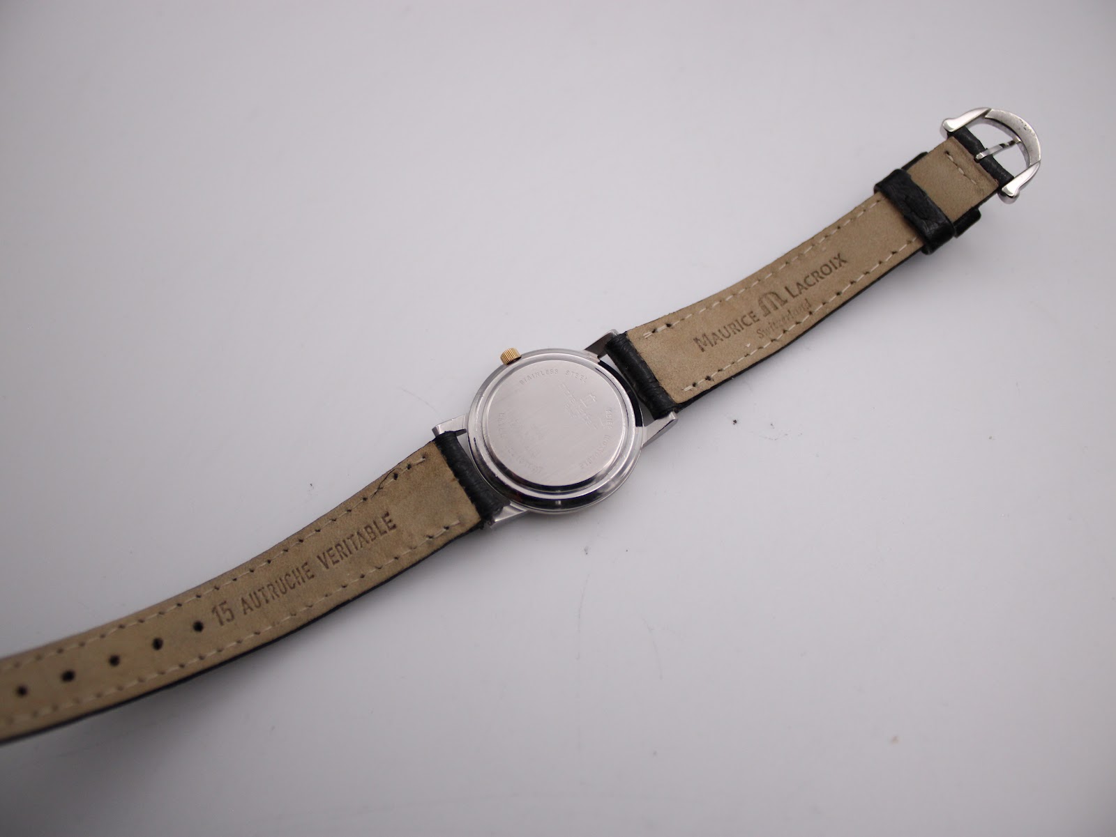 Full length back view of the Michel Herbelin watch, showing the case back and the underside of the Maurice Lacroix strap.