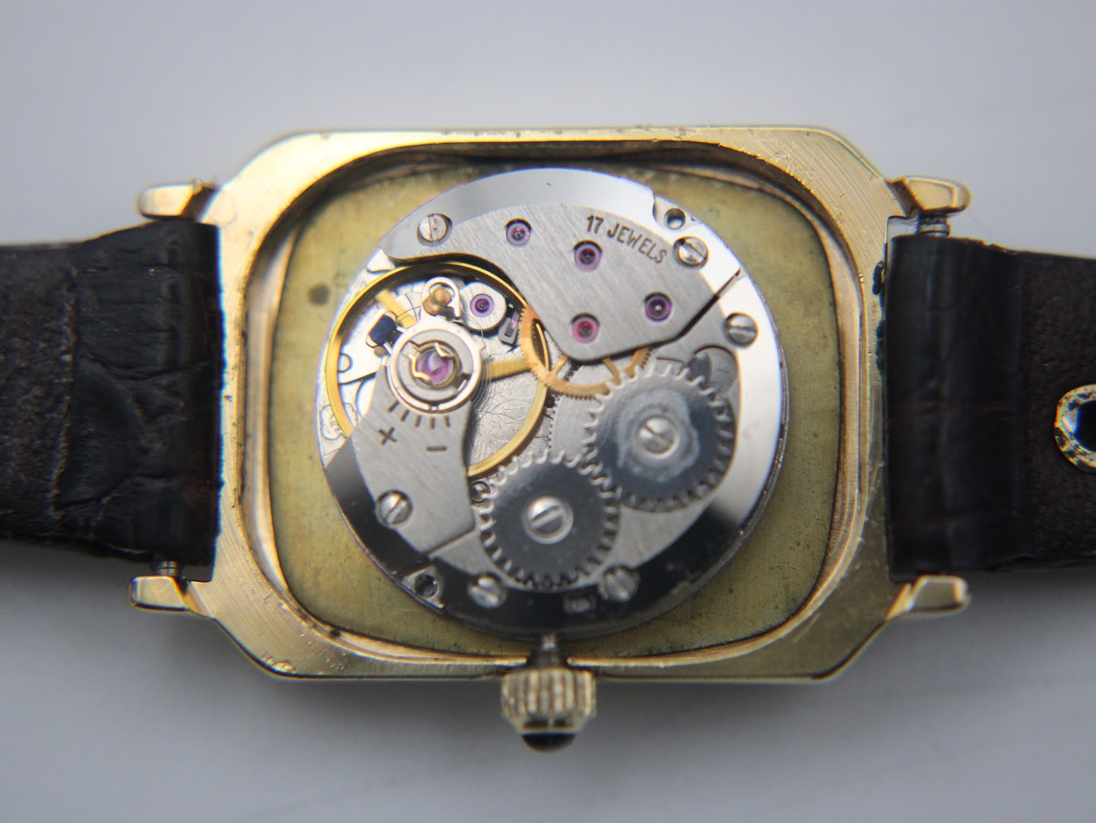 Detailed view of the 17 jewels manual wind mechanical movement visible inside the open watch case.