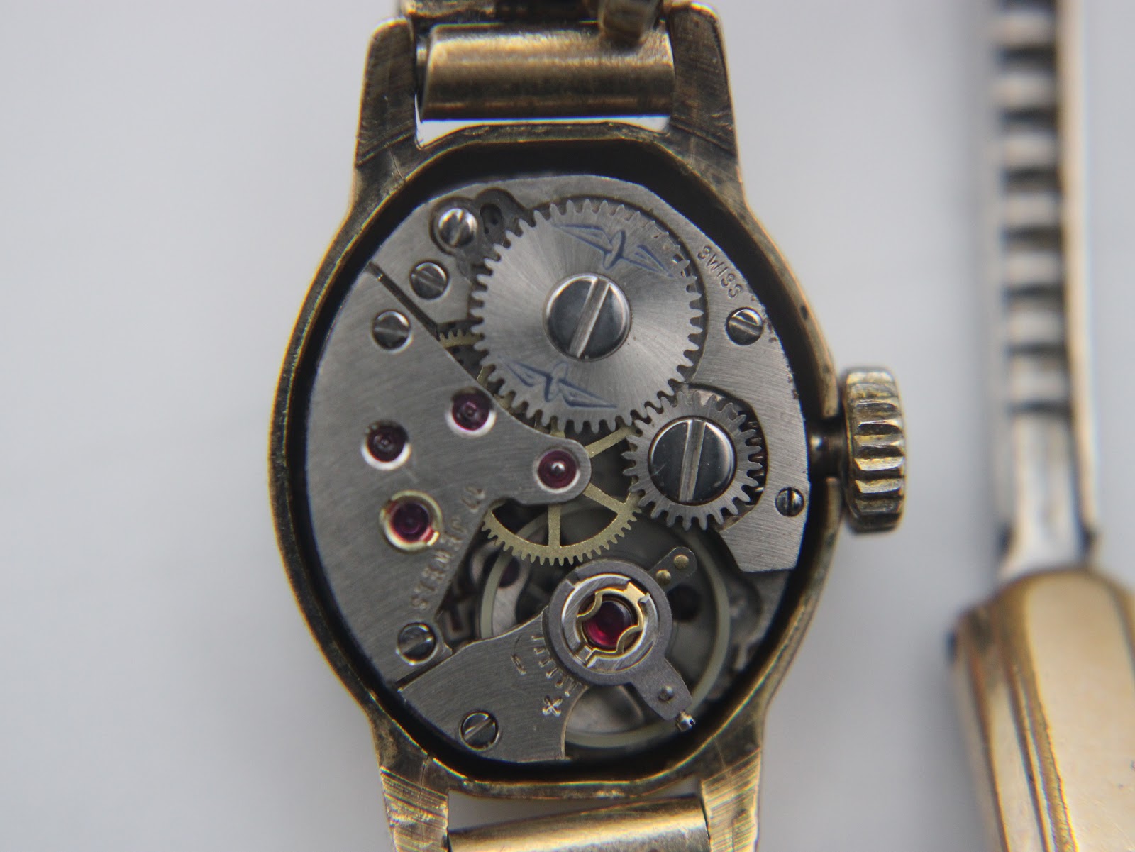 Macro shot of the manual wind Swiss movement with the case back removed.