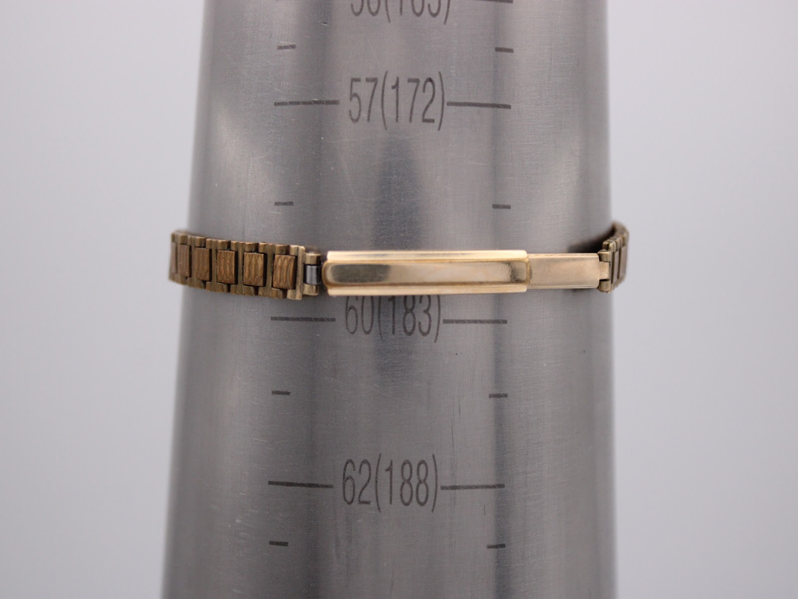 Gold-tone expansion bracelet of the Rotary watch on a wrist sizing cone, showing approx. 18.3cm circumference.