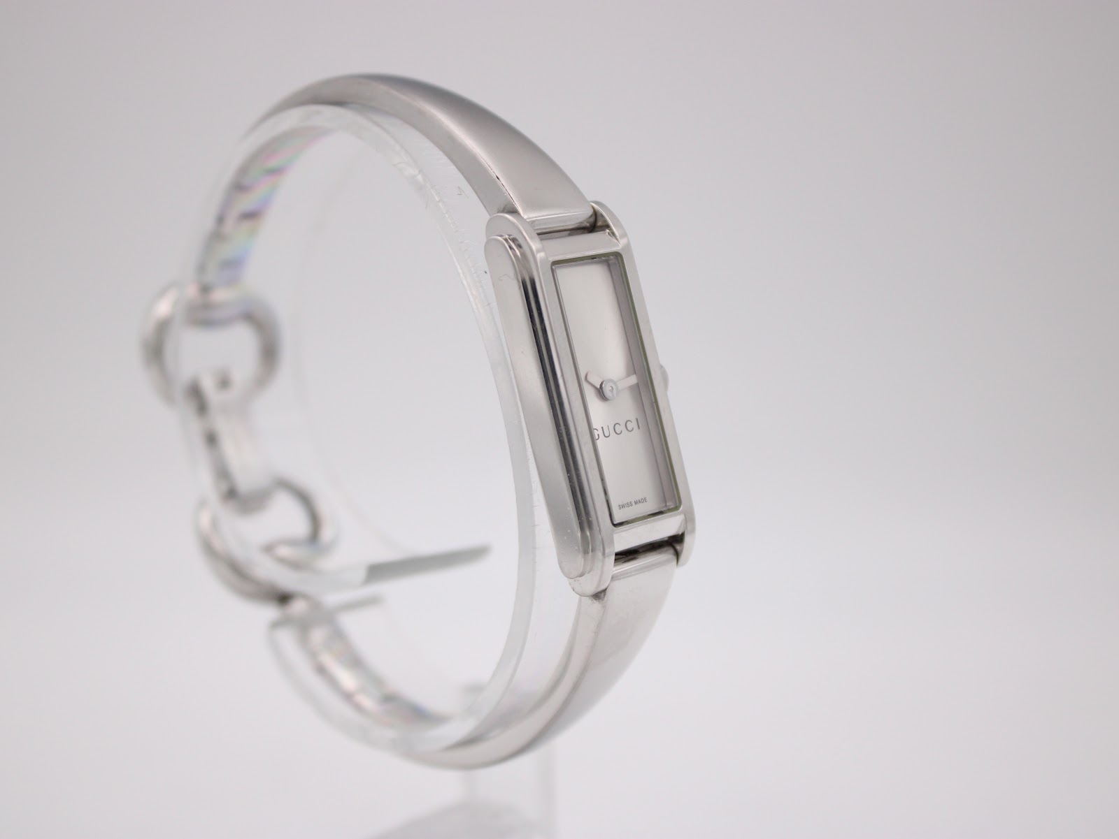 Three-quarter view of the Gucci 109 watch, highlighting its sleek case and fluid bangle bracelet.