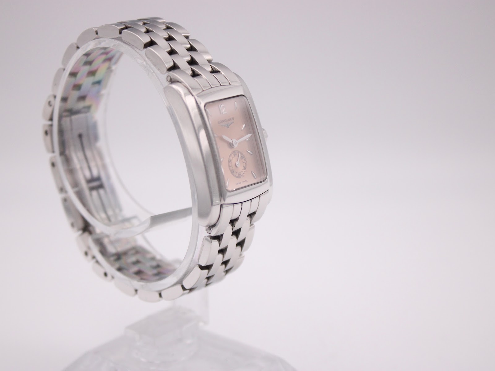 Another side profile view of the Longines watch, showcasing the case thickness and bracelet links.