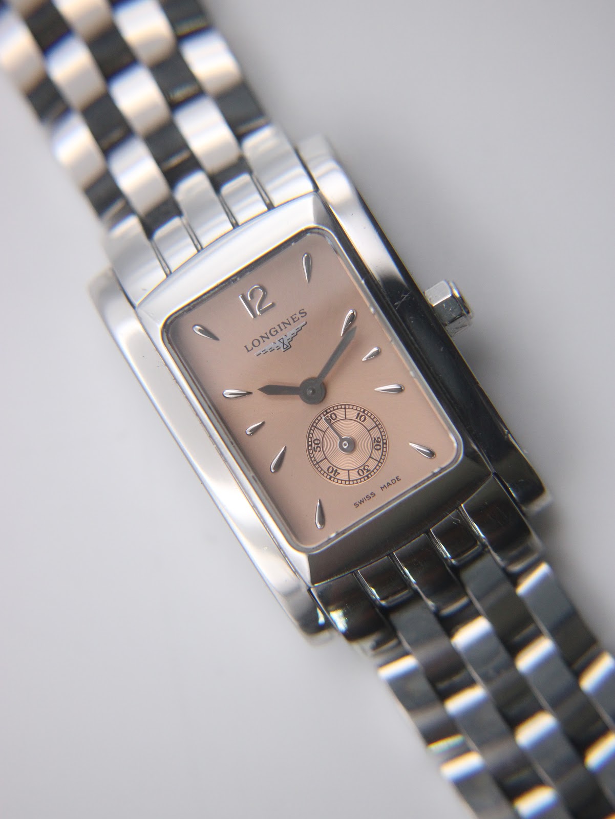 Angled close-up of the rose gold dial of the Longines 7751, showing the sub-seconds dial and applied baton indices.