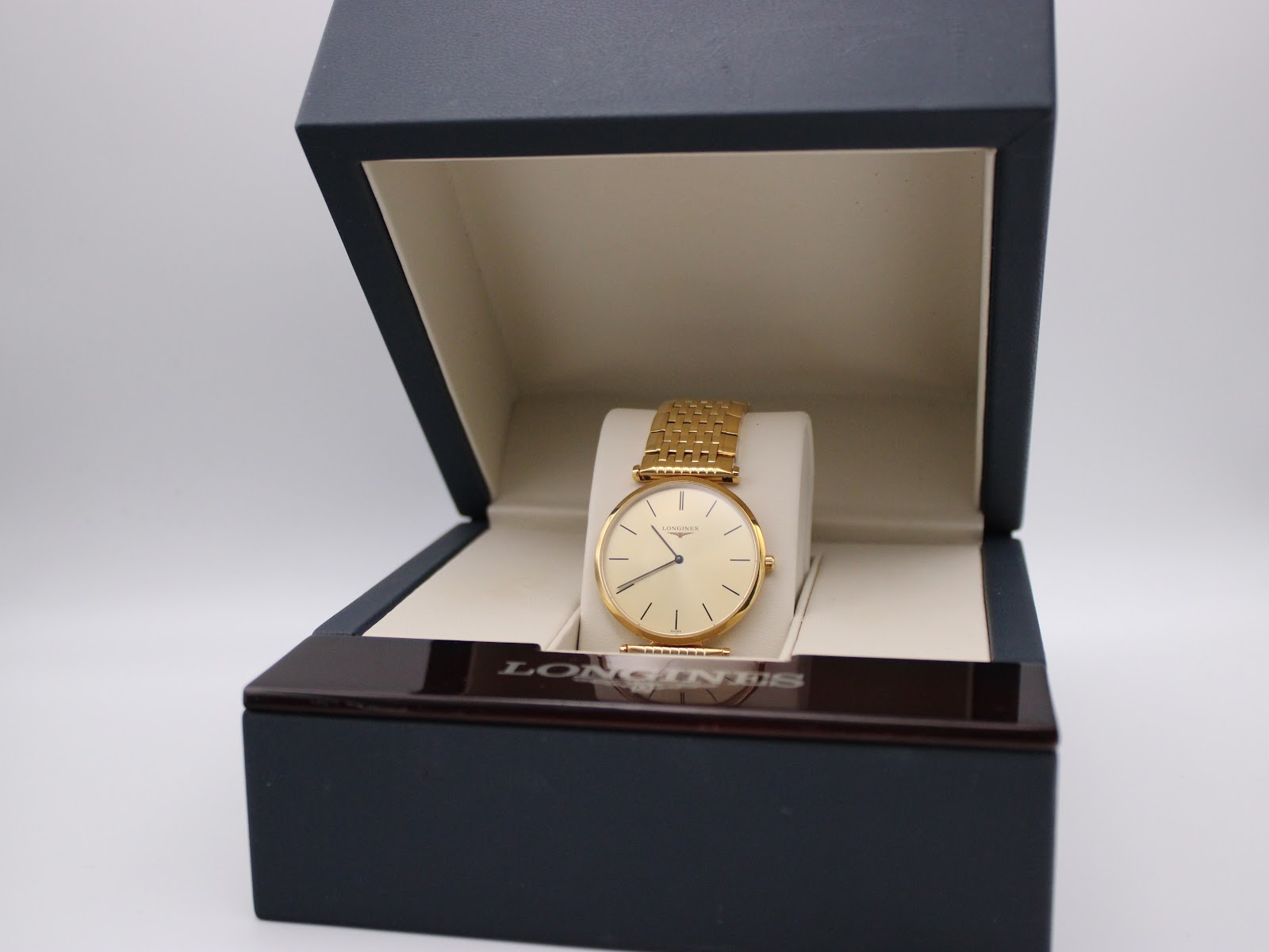 The Longines watch presented inside its original dark blue Longines box.