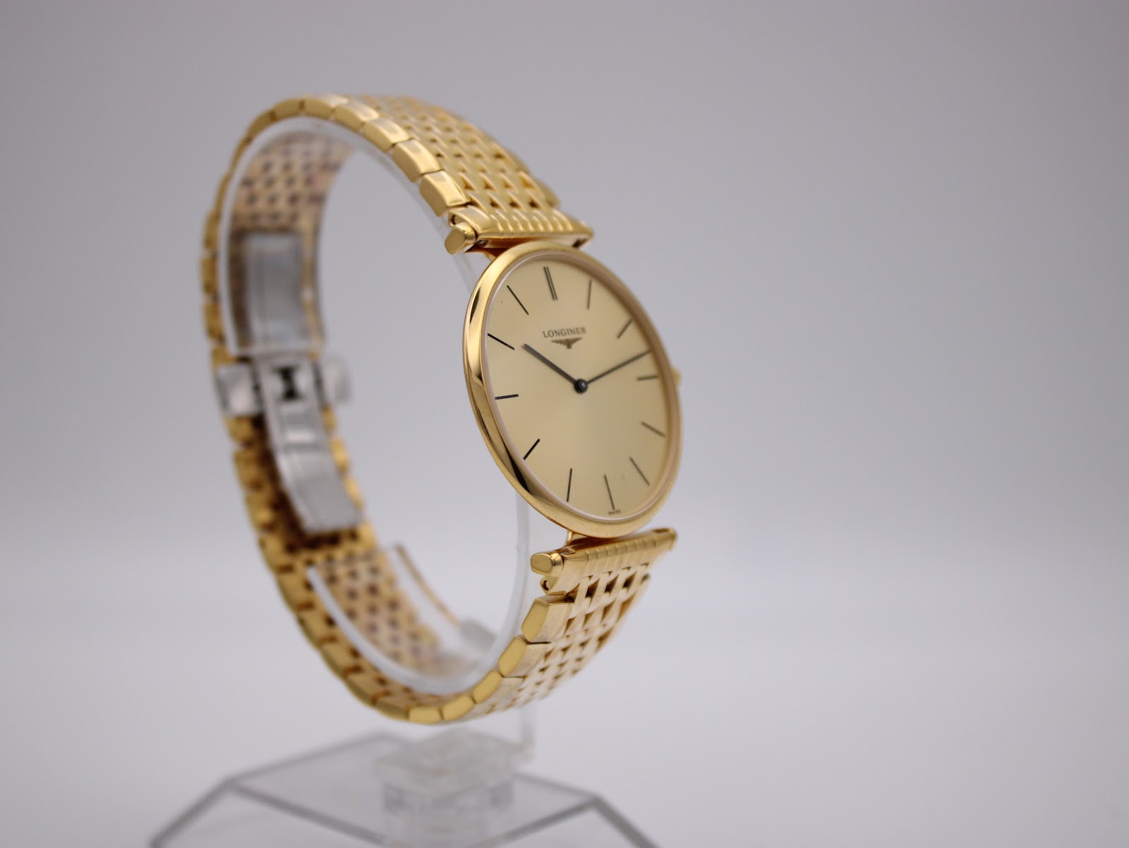 Another angled side view of the Longines watch, focusing on the elegant lines and the signed deployment clasp.