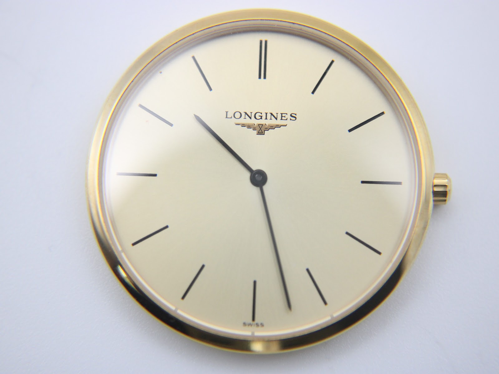 Close-up top-down view of the champagne dial, showing the Longines logo, baton indices, and 'SWISS' text at 6 o'clock.