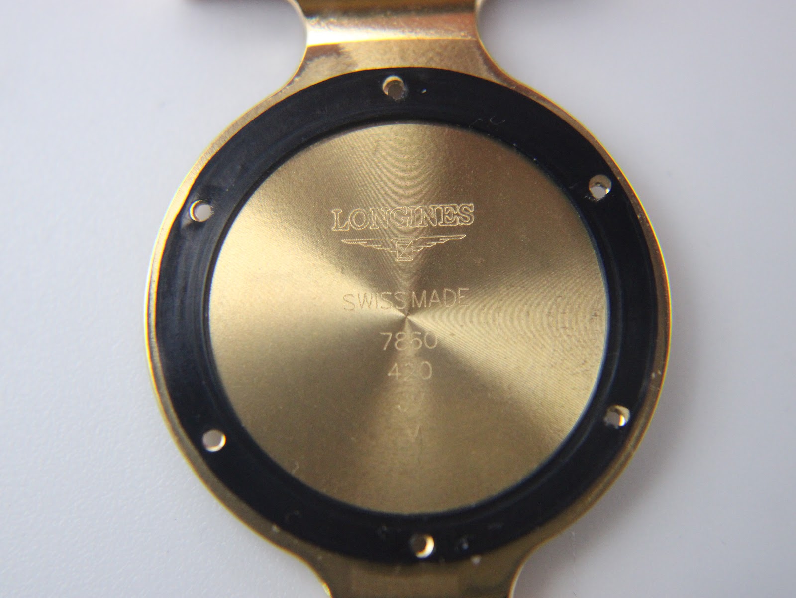 Inside view of the case back with 'LONGINES SWISS MADE' and other markings visible.