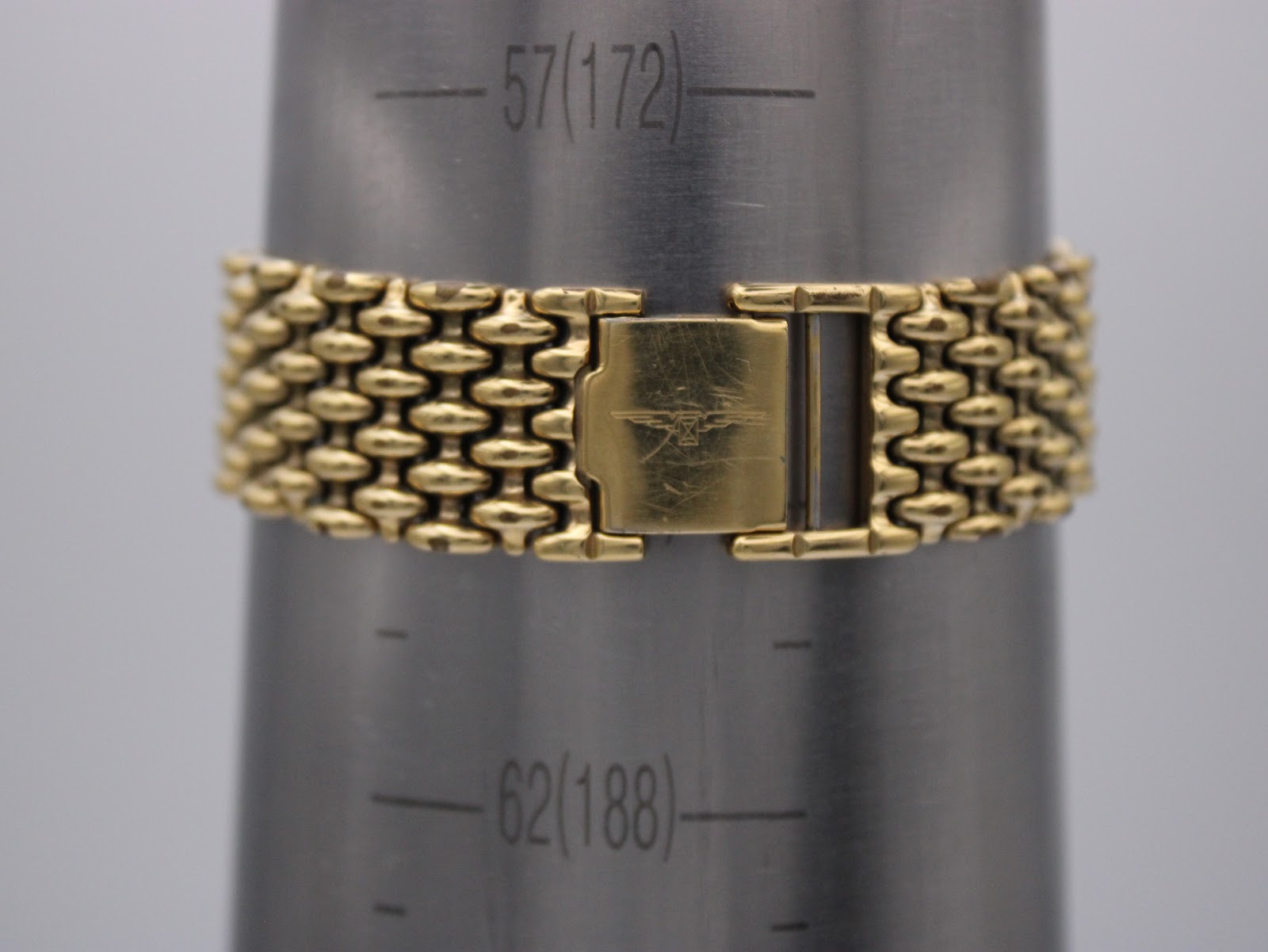 Close-up of the gold-tone bead-of-rice bracelet clasp, signed with the Longines logo, shown on a wrist sizing gauge indicating a circumference of 172mm.