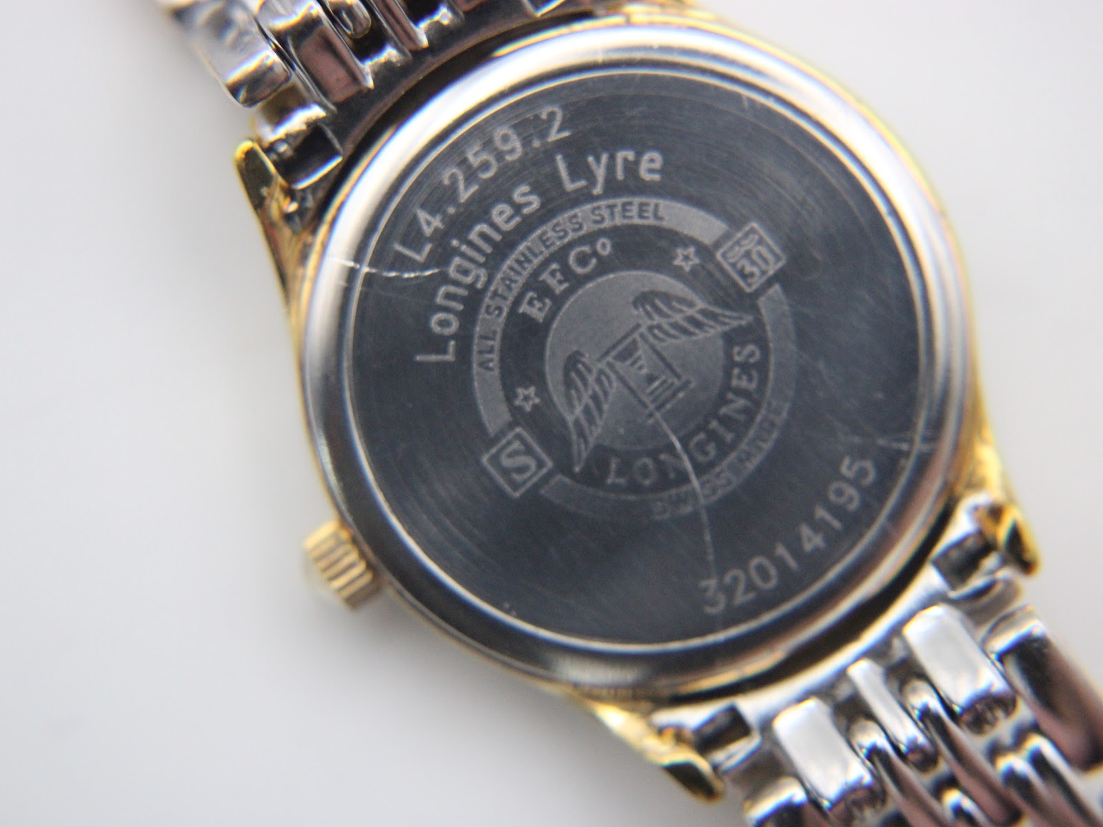 Close-up of the stainless steel case back of the Longines L.4.259.2 Lyre, showing model number, brand name, and serial number 32014195.