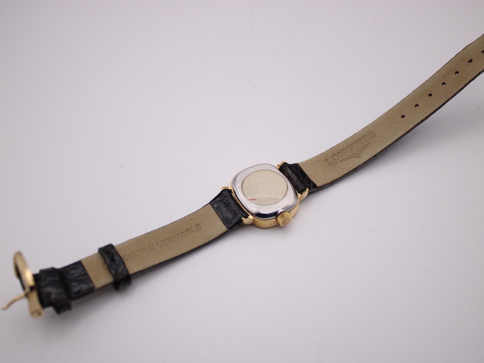 Back view of the Longines watch, showing the case back and the interior of the black leather strap.