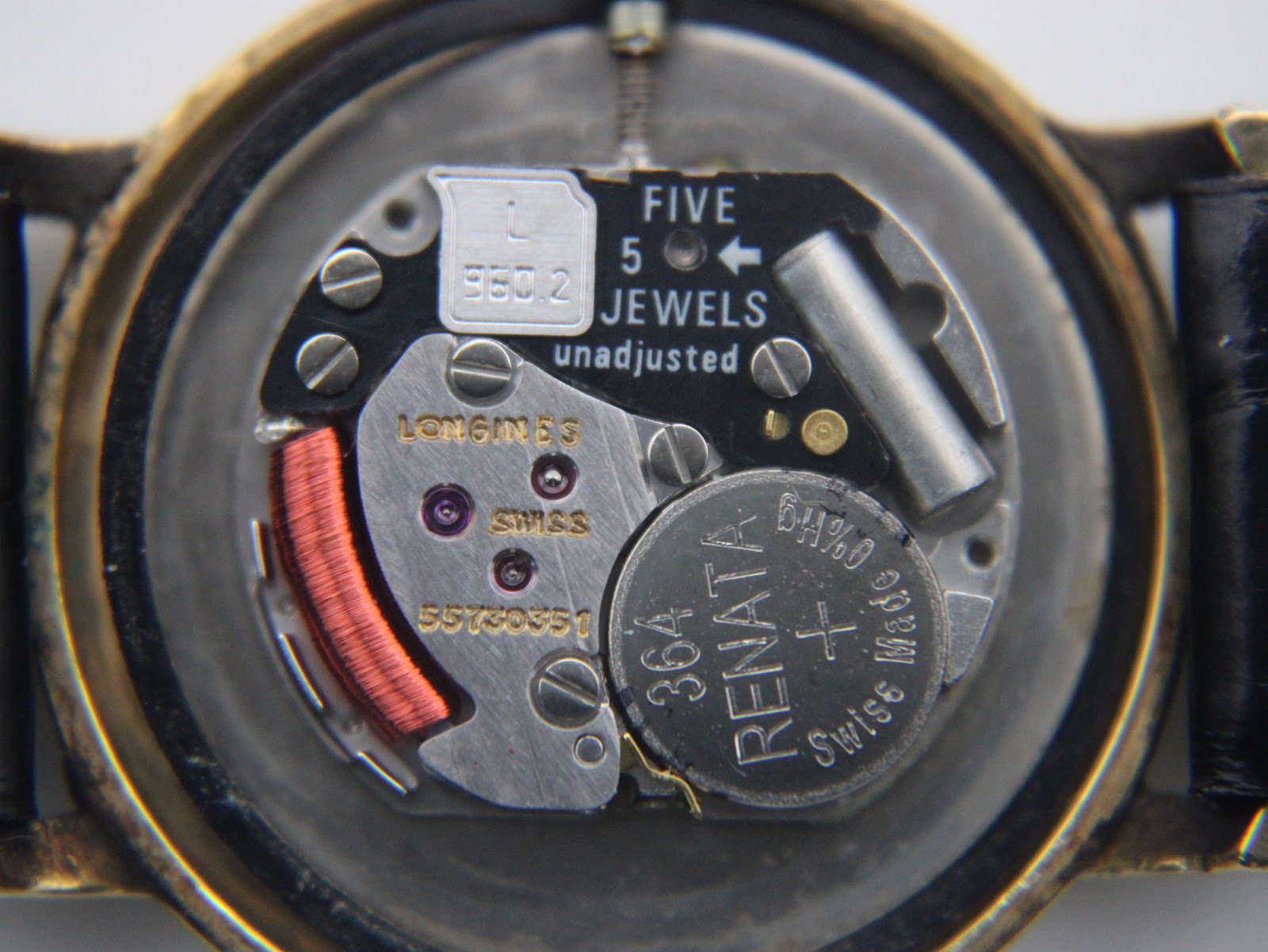 Detailed view of the Longines calibre 557.2 Swiss quartz movement, showing 'FIVE 5 JEWELS' and a Renata 364 battery.