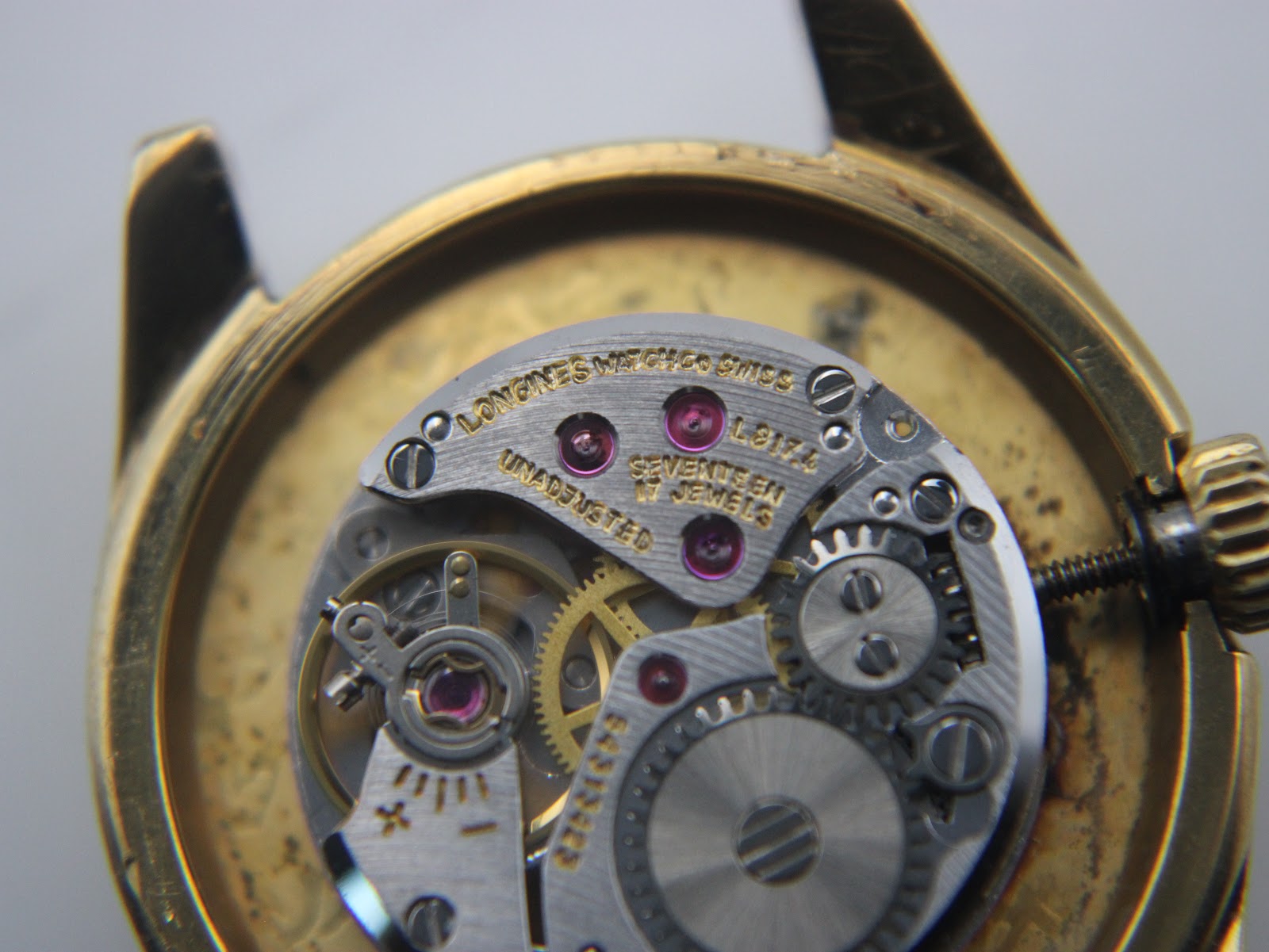 Angled close-up of the Longines manual wind movement, showing 'Longines Watch Co Swiss' and 'Seventeen 17 Jewels Unadjusted'.
