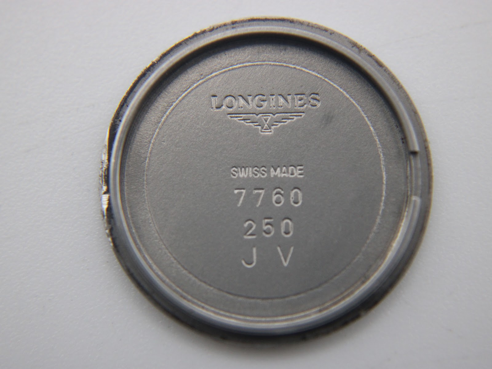 Inside view of the case back, showing 'LONGINES', 'SWISS MADE', and internal markings '7760 250 J V'.