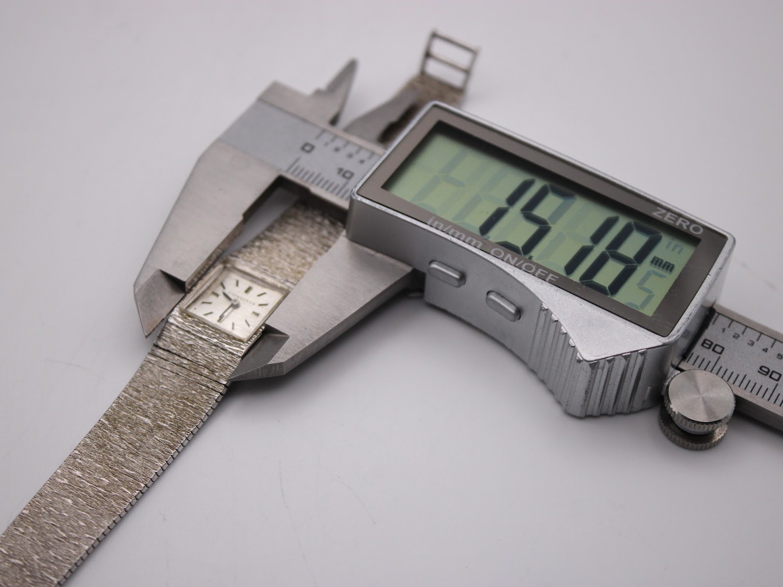 Digital caliper measuring the watch case diameter at precisely 15.18mm.