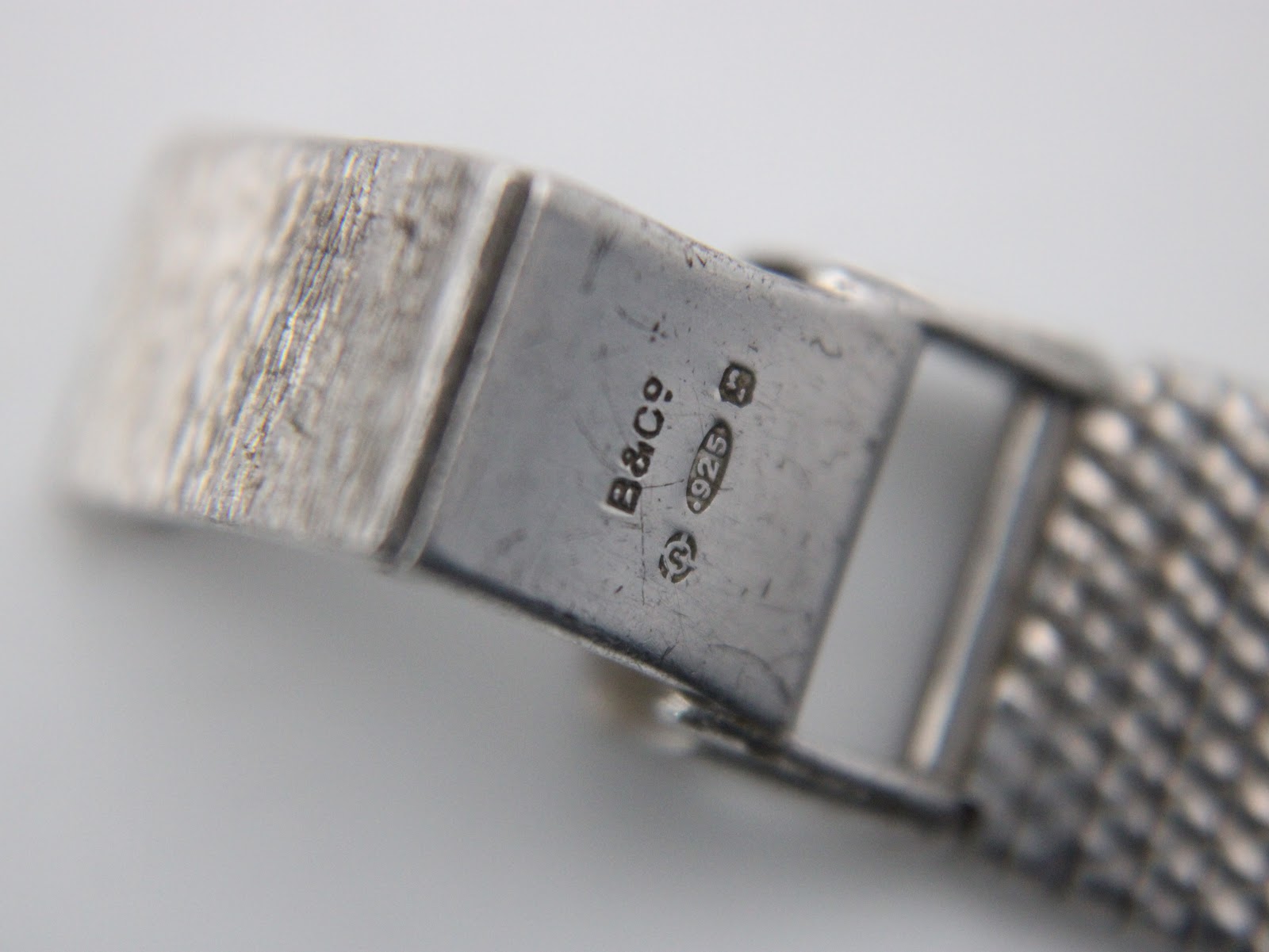 Close-up of the watch clasp showing the 'B&Co' maker's mark, '925' sterling silver stamp, and other hallmarks.