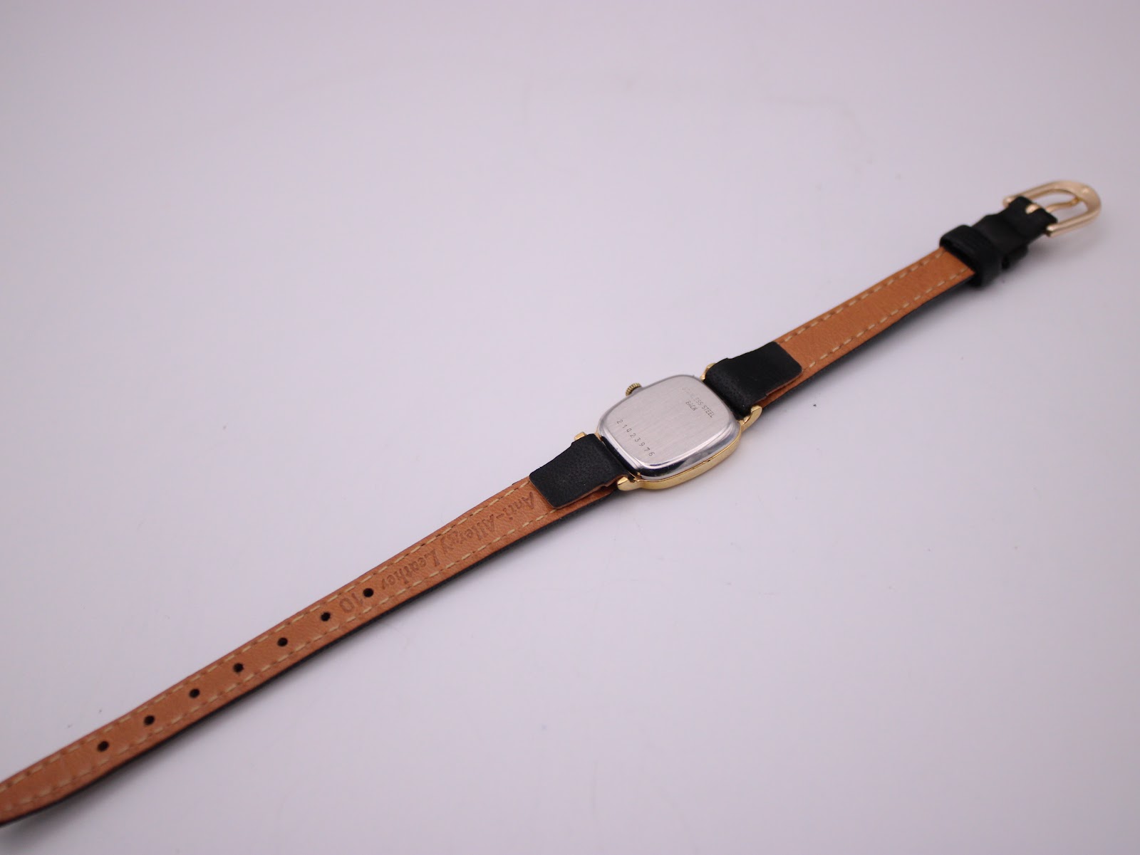 Back view of the Longines watch with its black leather strap fully extended, showing the stainless steel case back.