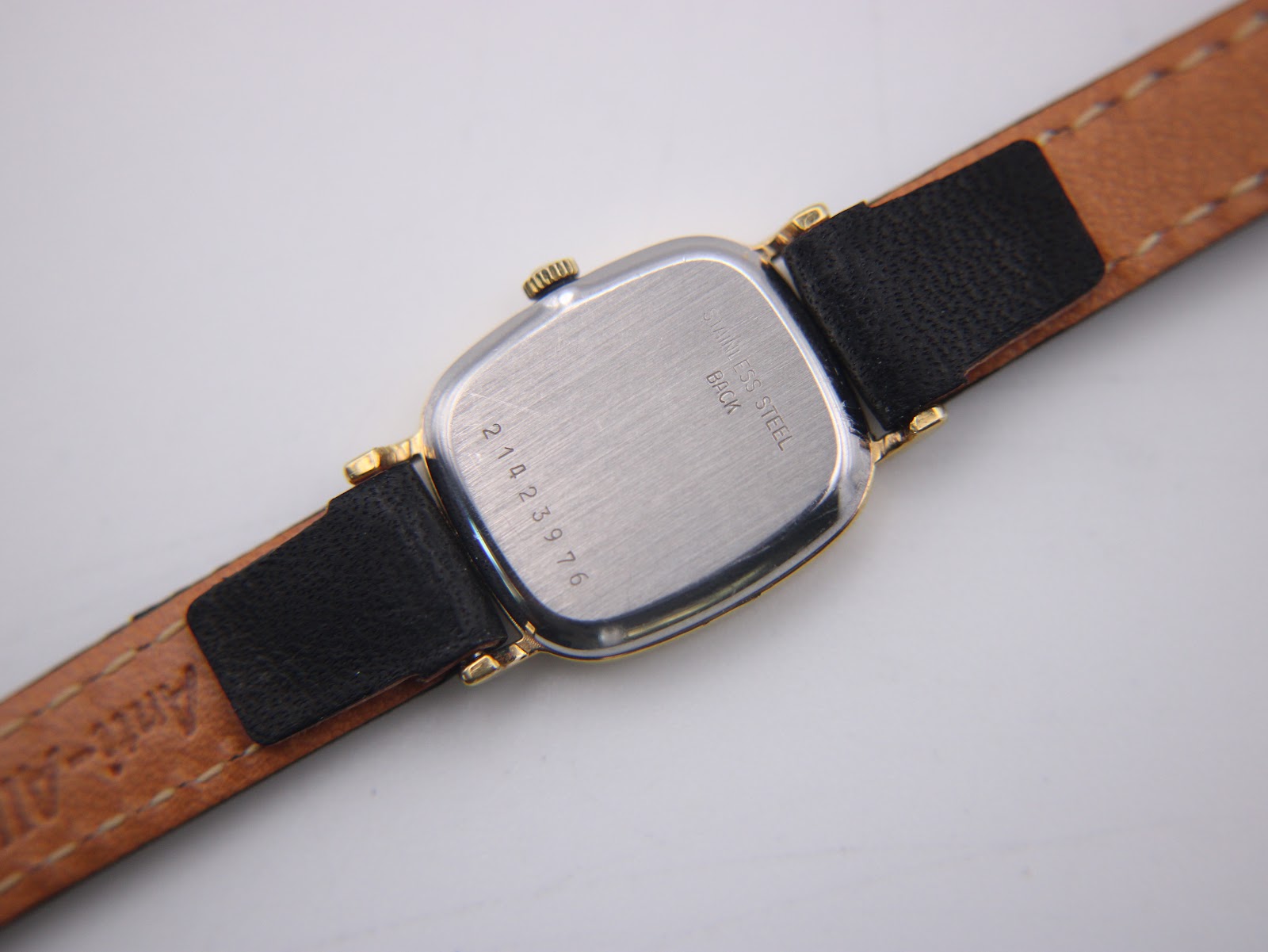 Close-up of the stainless steel case back of the Longines 6486, showing model number and serial number 211023976.