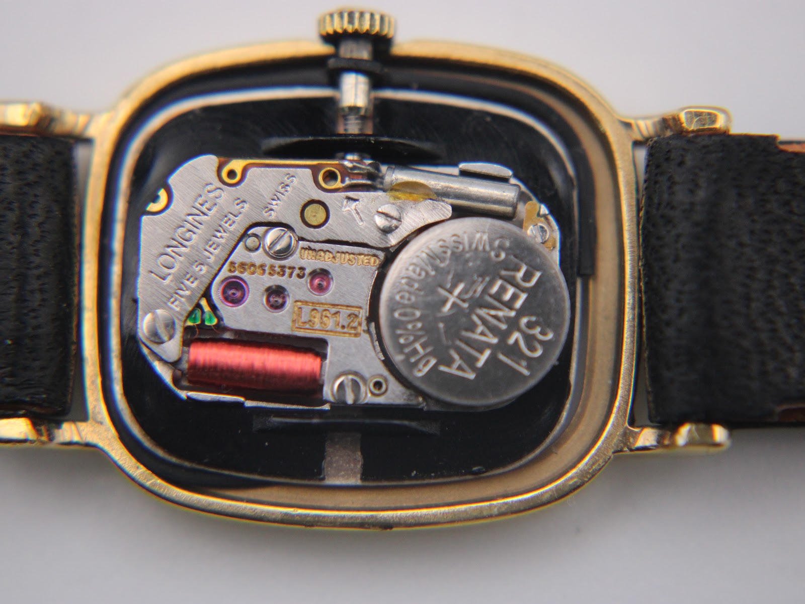Macro shot of the Longines L961.2 Swiss quartz movement with a Renata 321 battery visible inside the watch case.