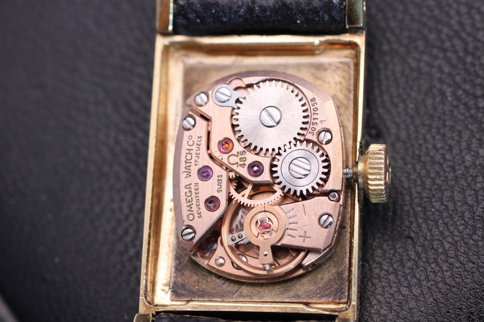 Close-up of the Omega Calibre 485 manual wind movement, showing 'OMEGA WATCH Co' and the 17 jewels.