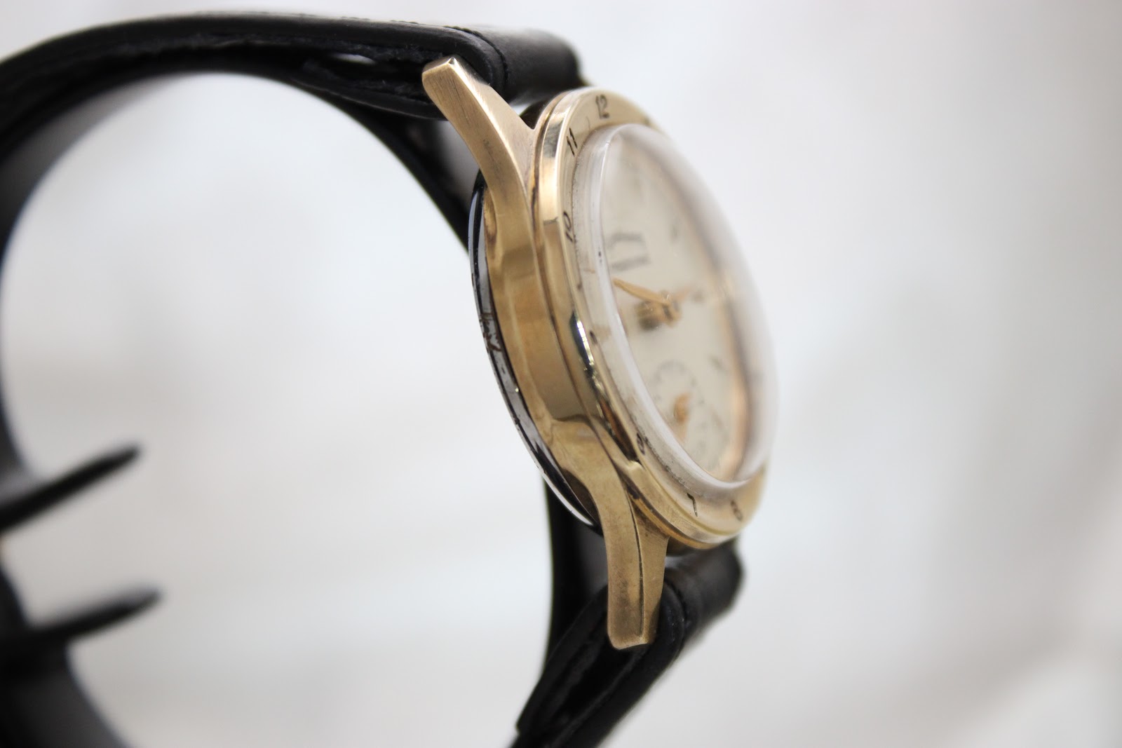 Another side view of the Services Marine watch on a display stand, focusing on the curved lugs and the case thickness.
