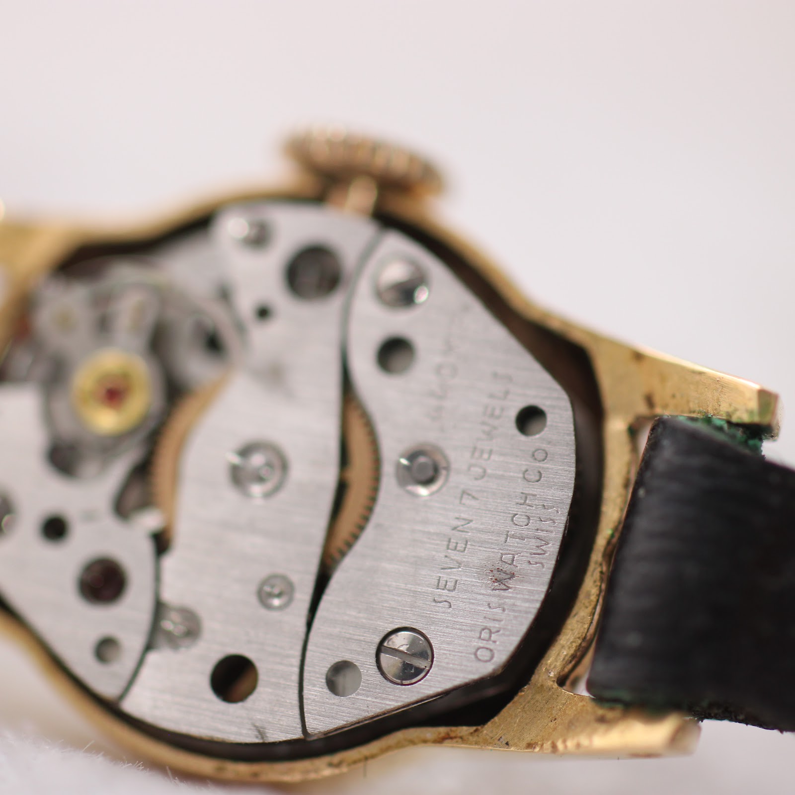 Detailed close-up of the manual wind mechanical movement, clearly showing 'SEVEN 7 JEWELS' and 'ORIS WATCH CO SWISS' engravings.