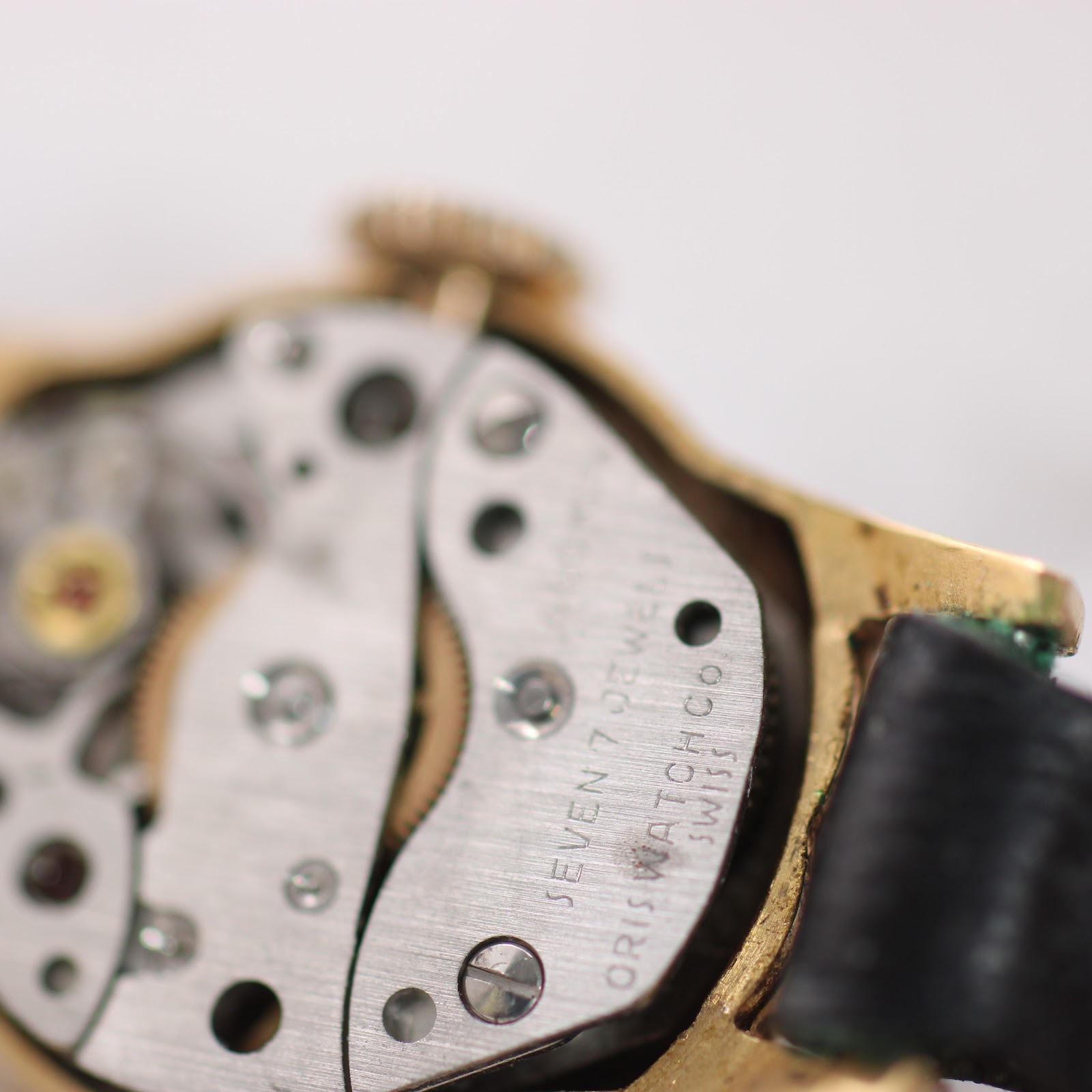 Another close-up perspective of the watch's manual wind movement, revealing the intricate gears and 'SEVEN 7 JEWELS' inscription.