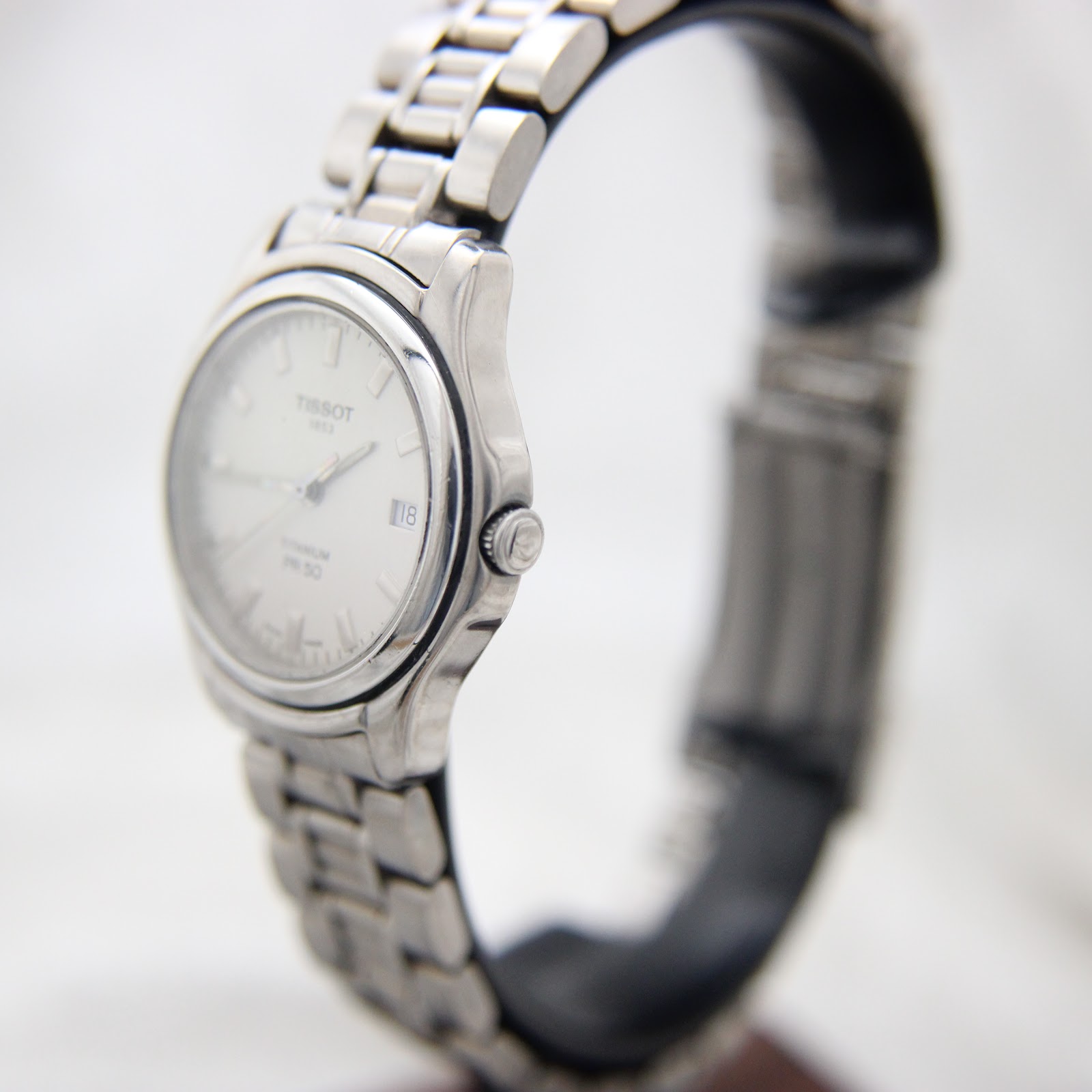 Side profile of the Tissot titanium watch showing case thickness