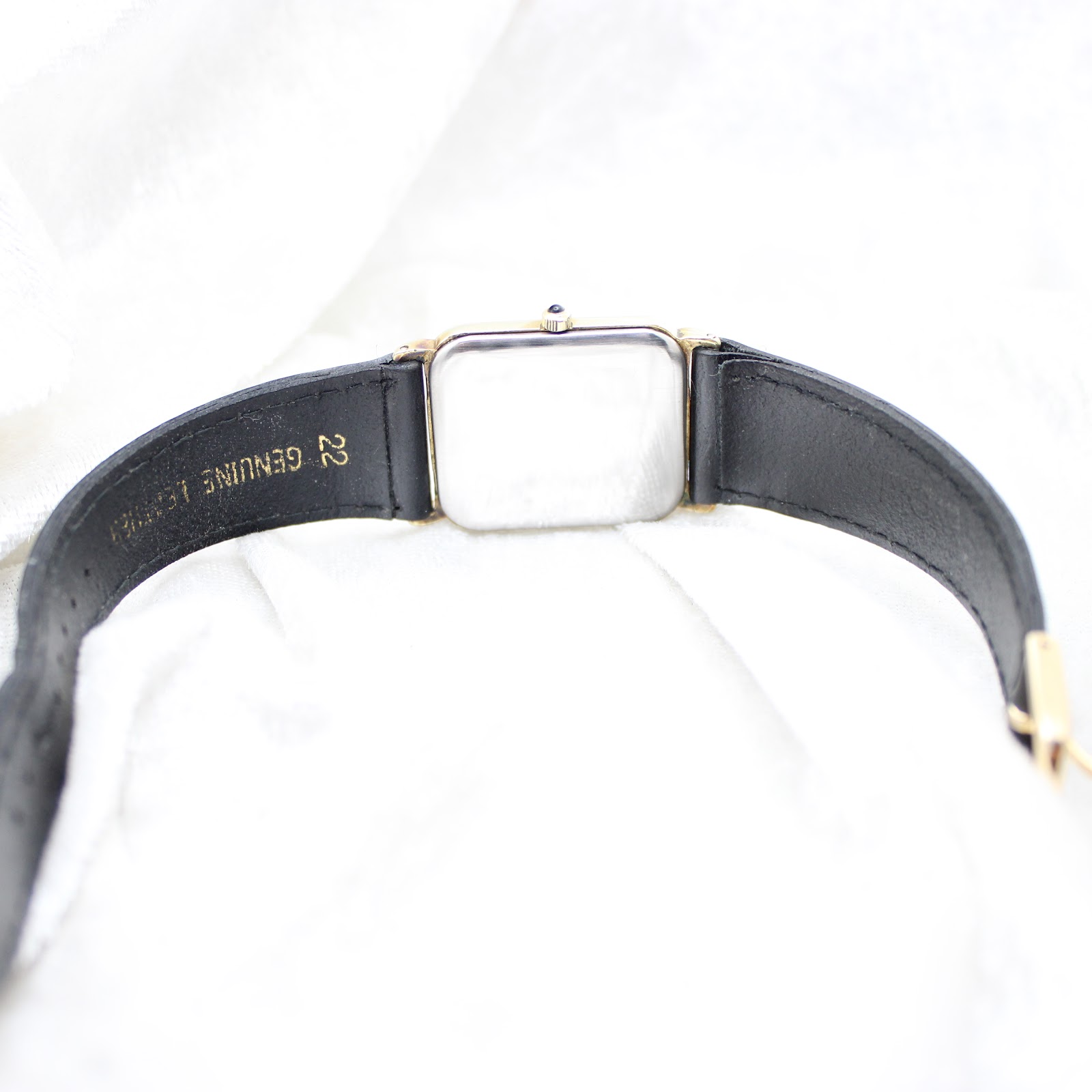 Detailed shot of the black dial, showing gold-tone hands and date window at 6 o'clock.