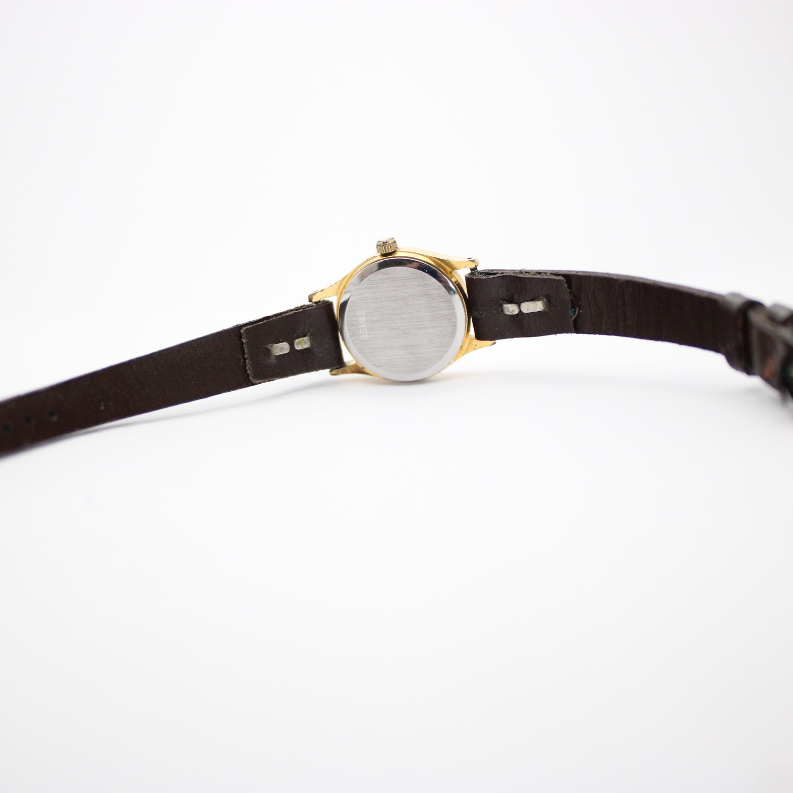 Back view of the Tissot Seastar watch, highlighting the stainless steel case back and the dark brown leather strap.