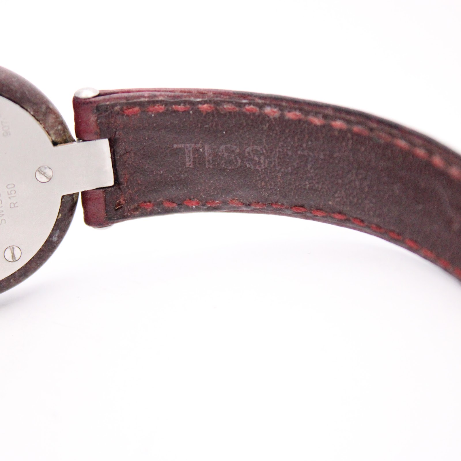 Close-up of the interior of the red leather strap, showing the embossed "TISSOT" logo.