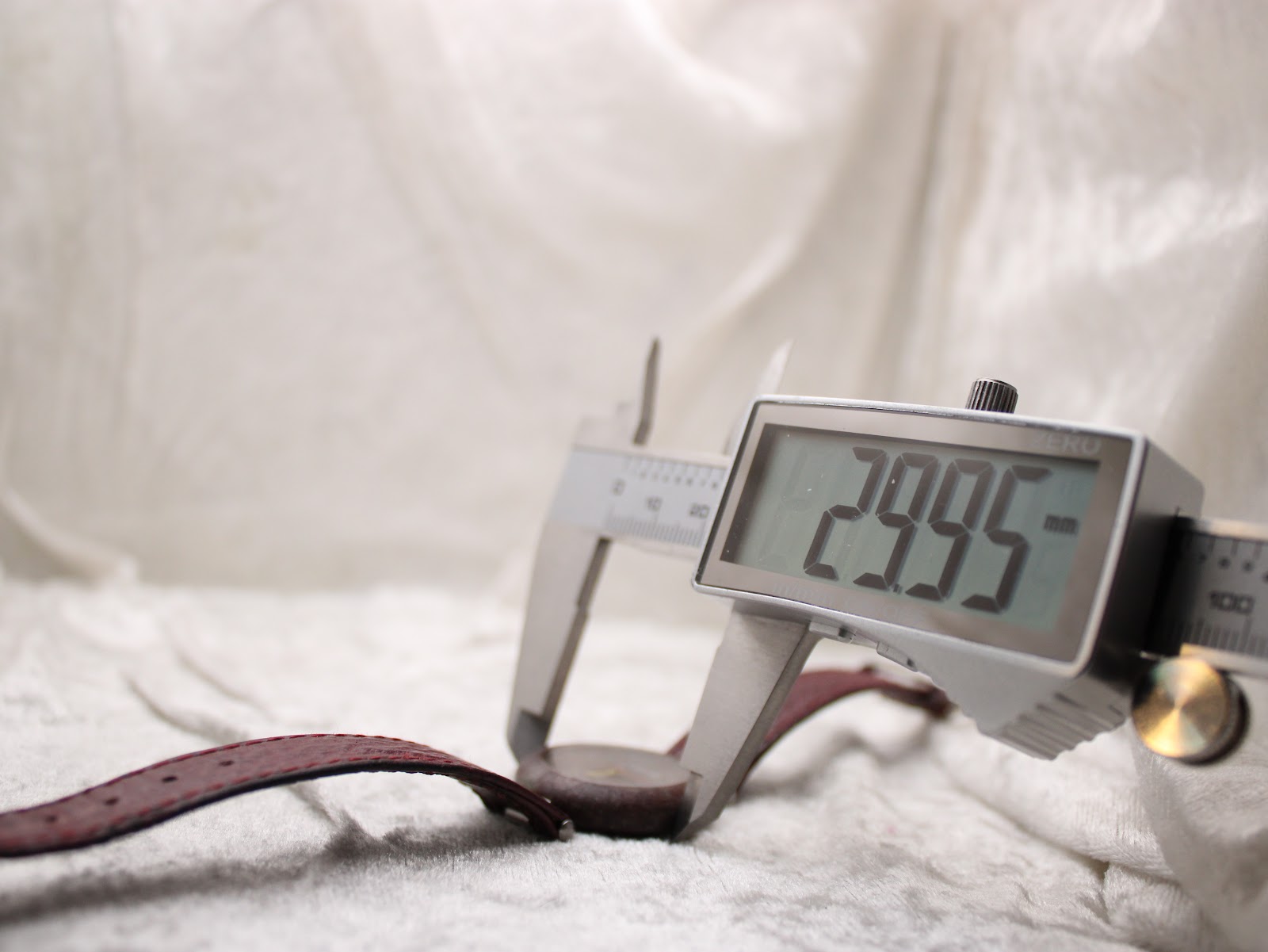 Digital caliper measuring the case diameter of the Tissot Rock Watch, displaying a precise reading of 29.95mm.