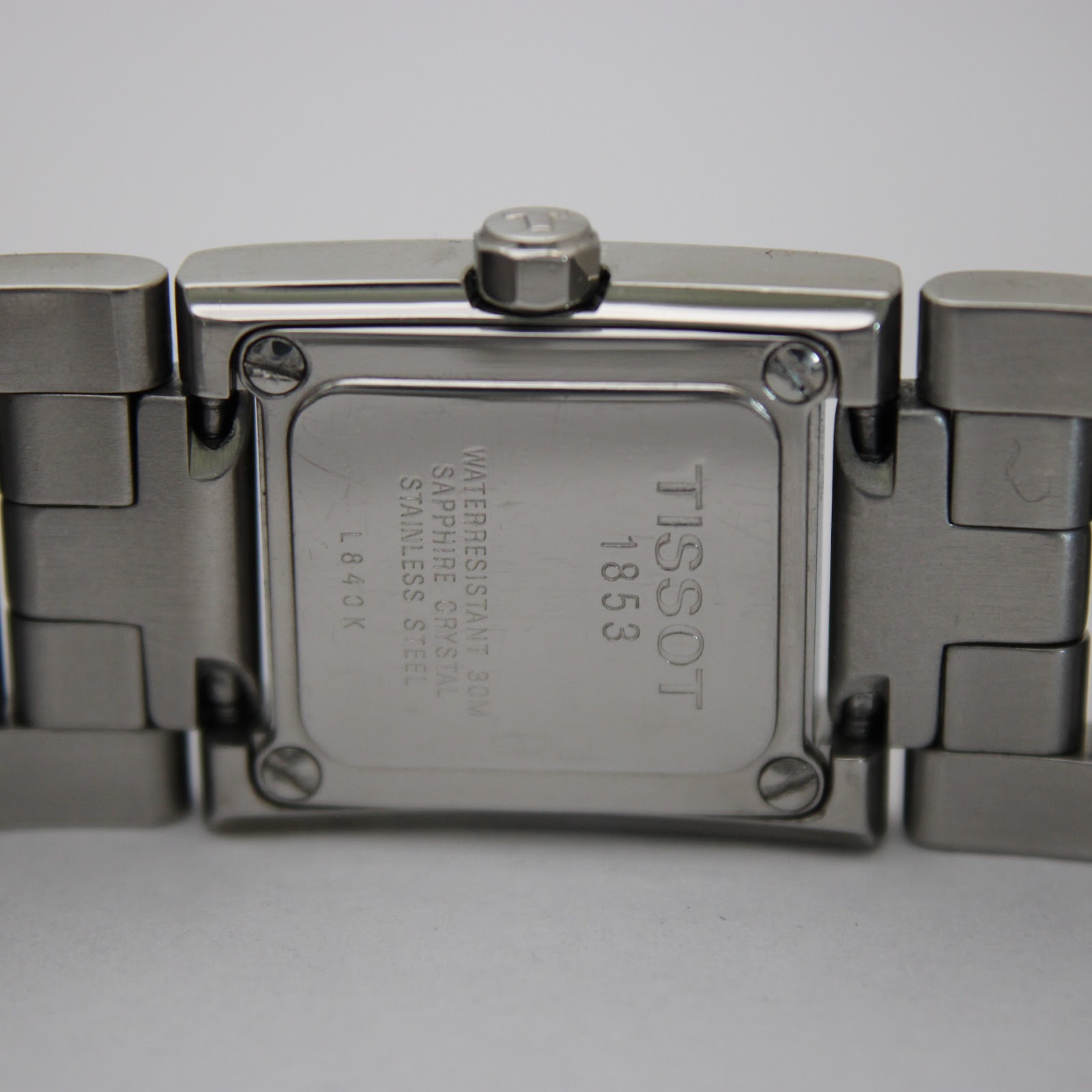 Close-up of the stainless steel case back, clearly showing "Tissot 1853", "L840 K", "Water Resistant 30M", "Sapphire Crystal", and "Stainless Steel" engravings.