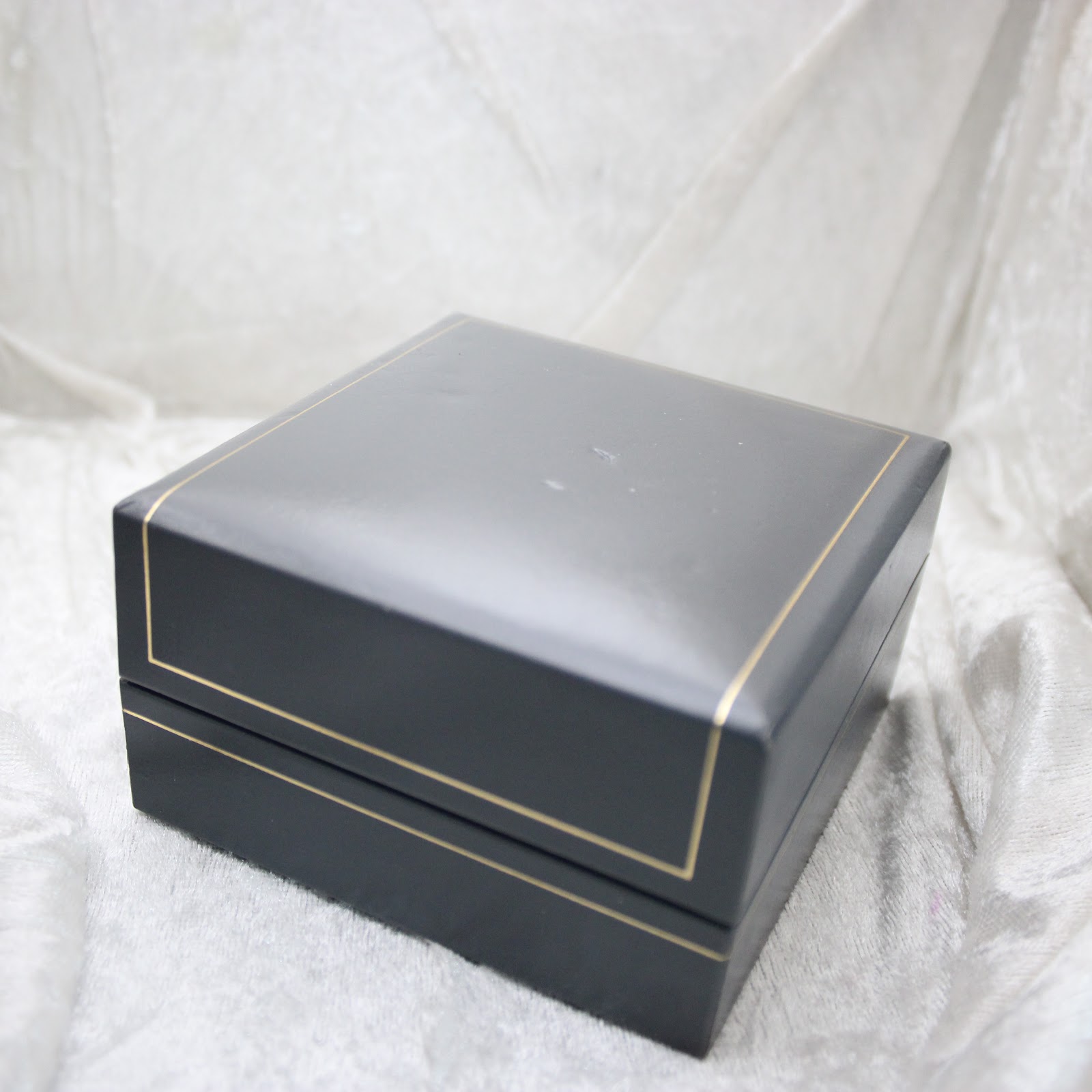 Close-up of the closed Dunhill original presentation box with gold trim.