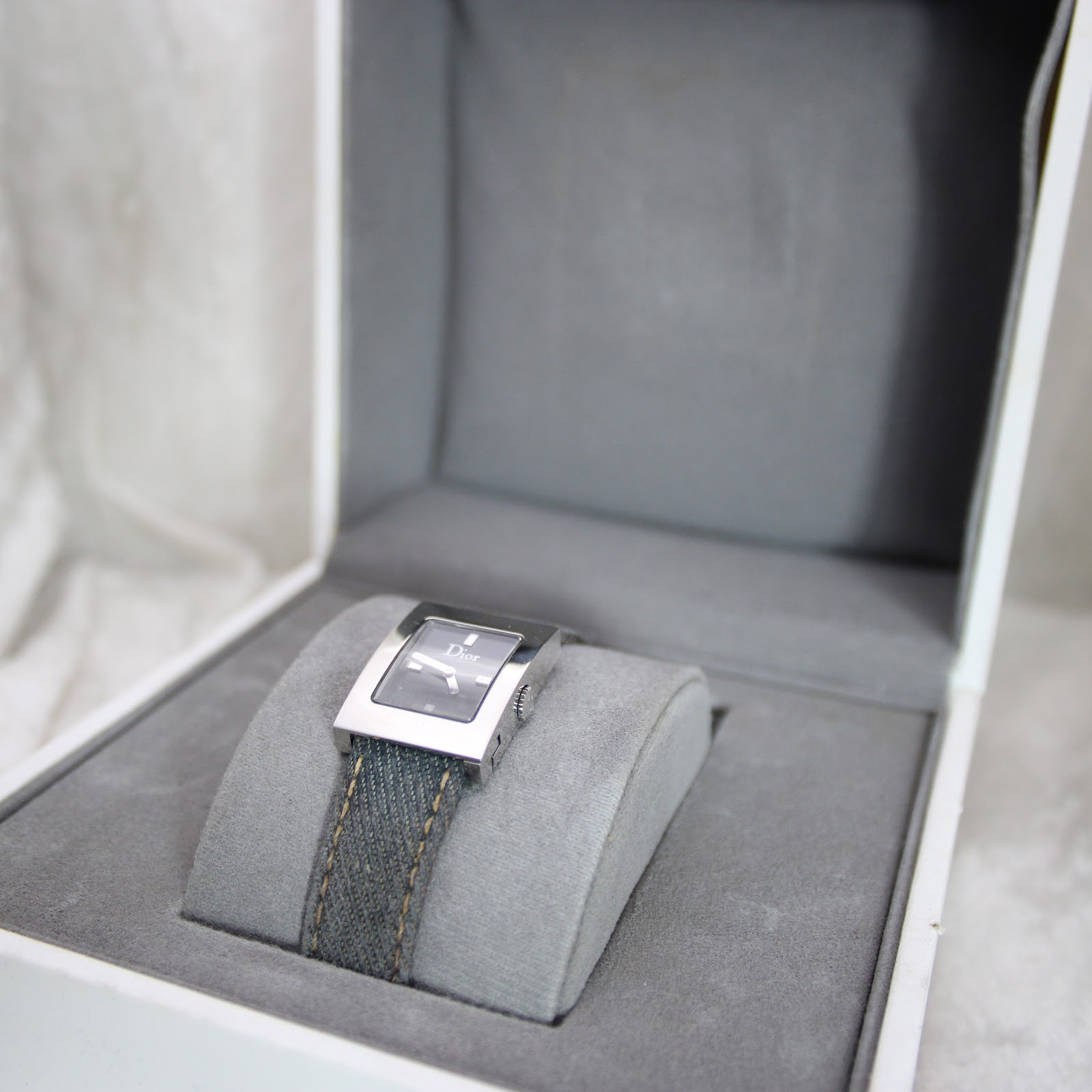 Christian Dior D78-109 watch nestled inside its original white presentation box on a grey cushion.