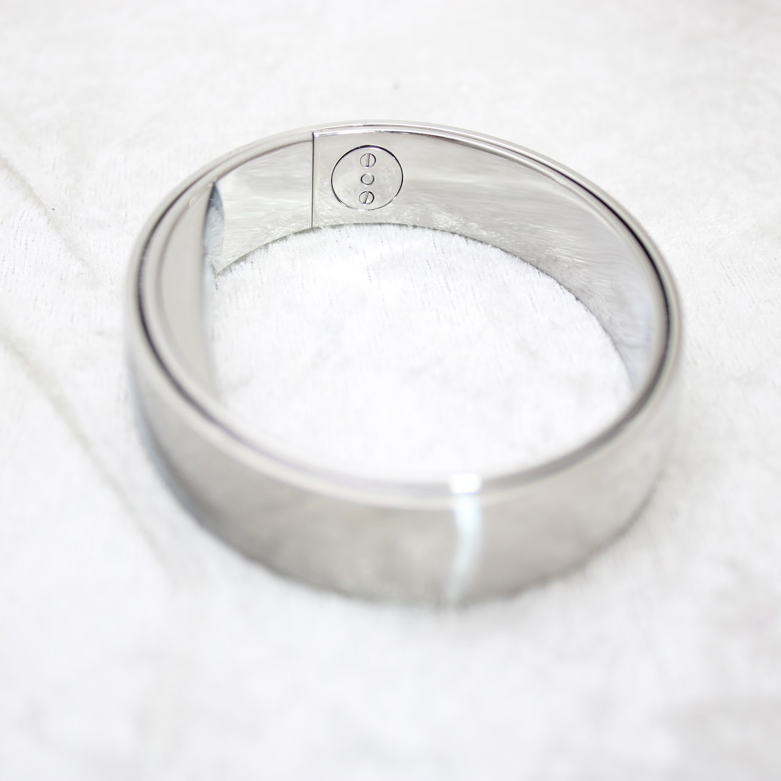 Another angle of the polished stainless steel bangle watch's integrated clasp mechanism, open.