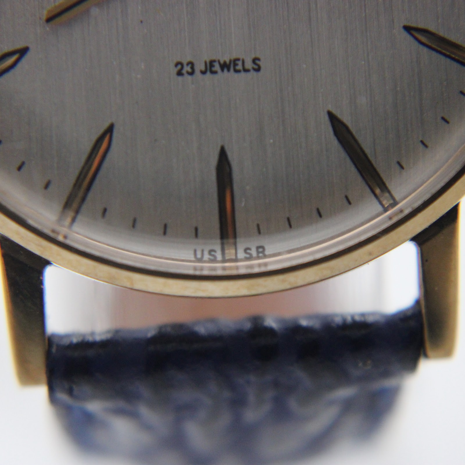 Close-up of the silver sunburst dial showing "23 JEWELS" and "USSR" text.