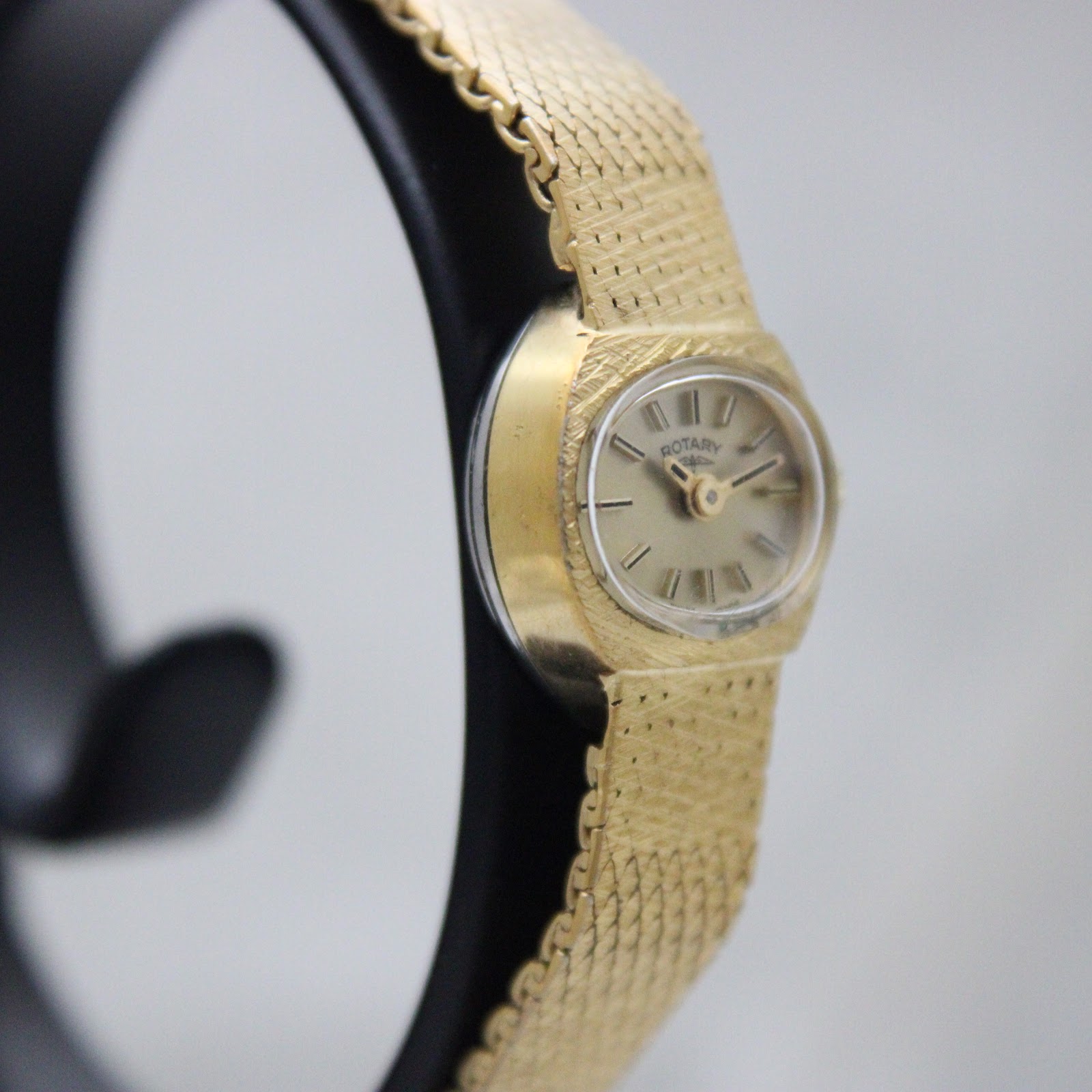 Another side-angled view of the Rotary watch, highlighting the case profile and bracelet texture.