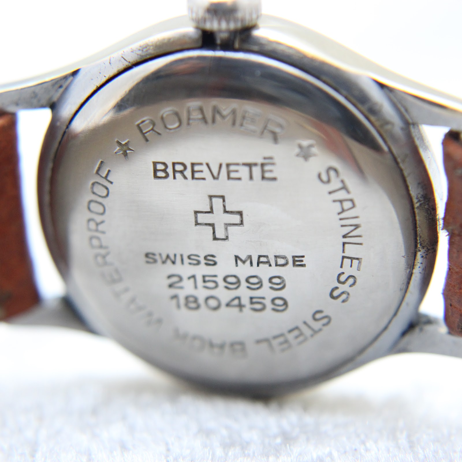 Detailed view of the stainless steel case back, engraved with 'ROAMER BREVETÉ SWISS MADE' and serial numbers.